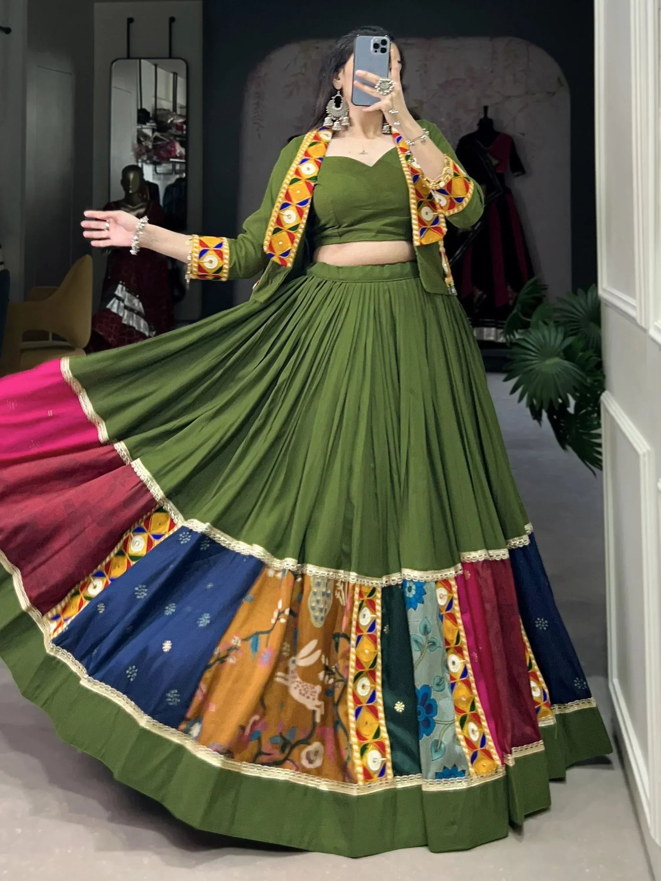 Green embroidered lehenga choli with colorful patchwork skirt, perfect for Indian ethnic wear occasions.