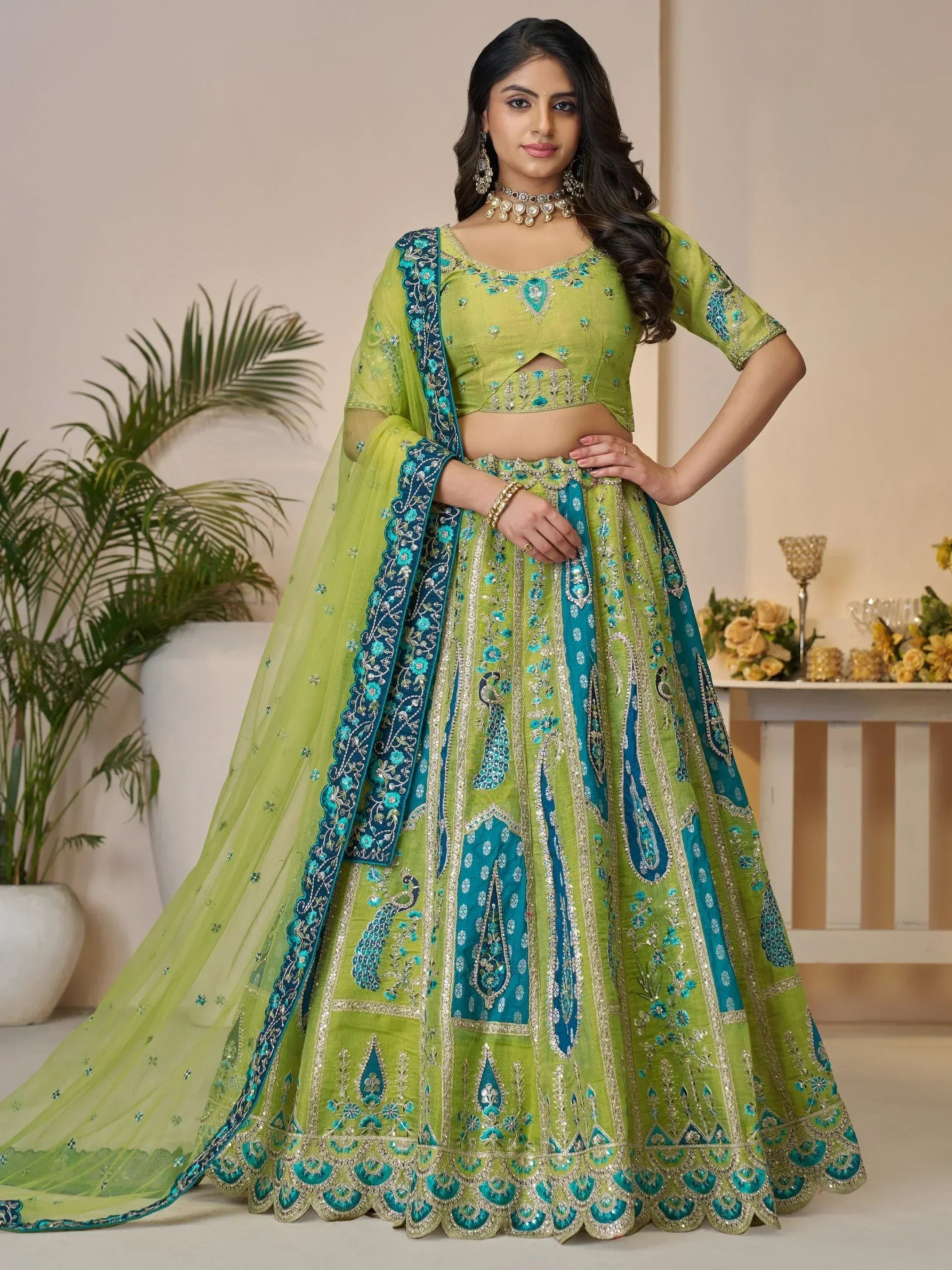 Green and teal embroidered lehenga choli with peacock motifs, perfect for Indian ethnic wear events
