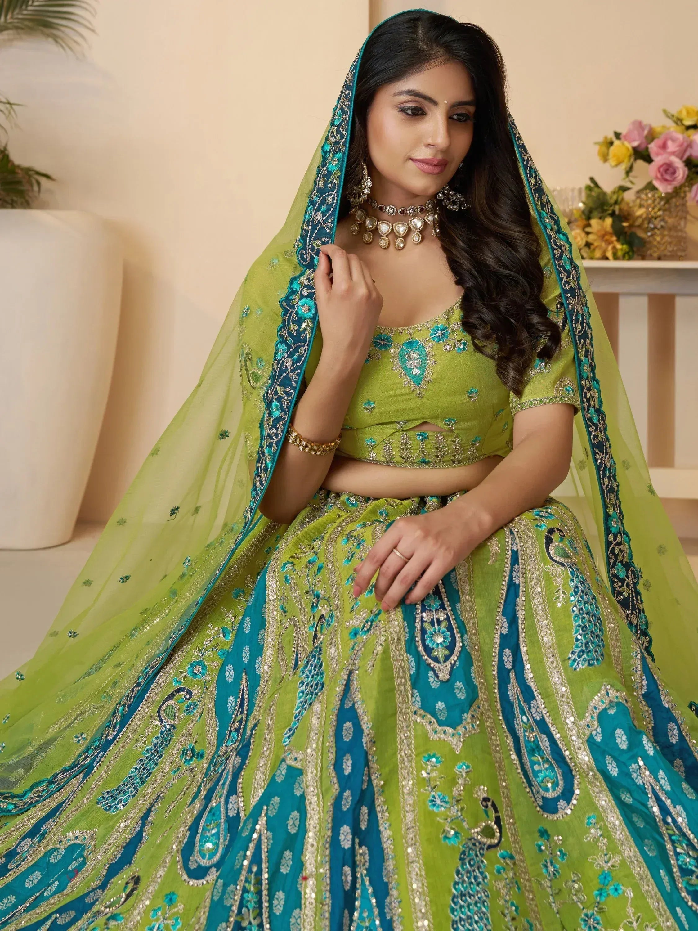Green and teal embroidered lehenga choli with peacock motifs, perfect for Indian ethnic wear occasions