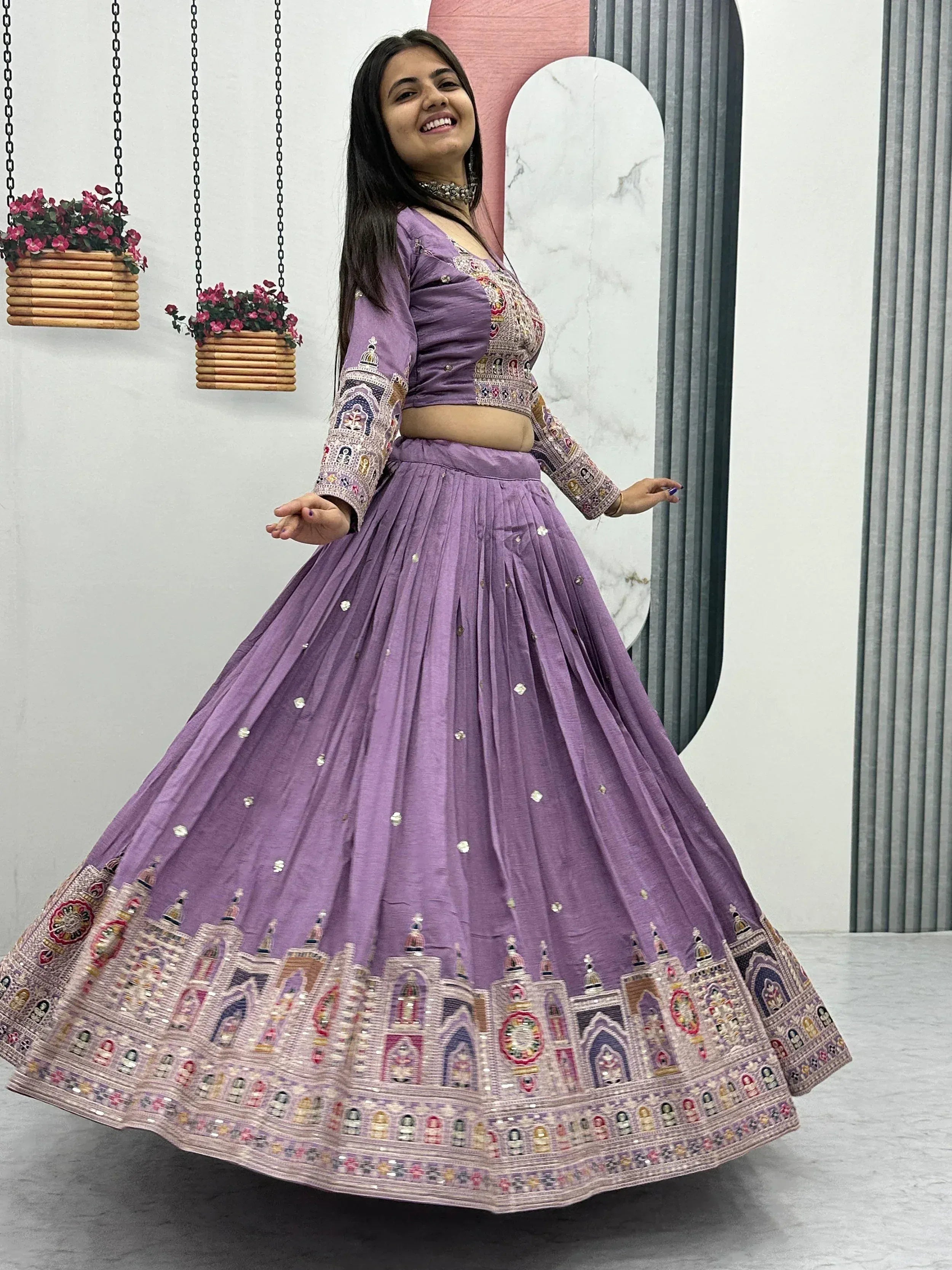 Purple embroidered lehenga choli with intricate mirror work and temple motifs, perfect for Indian ethnic wear.