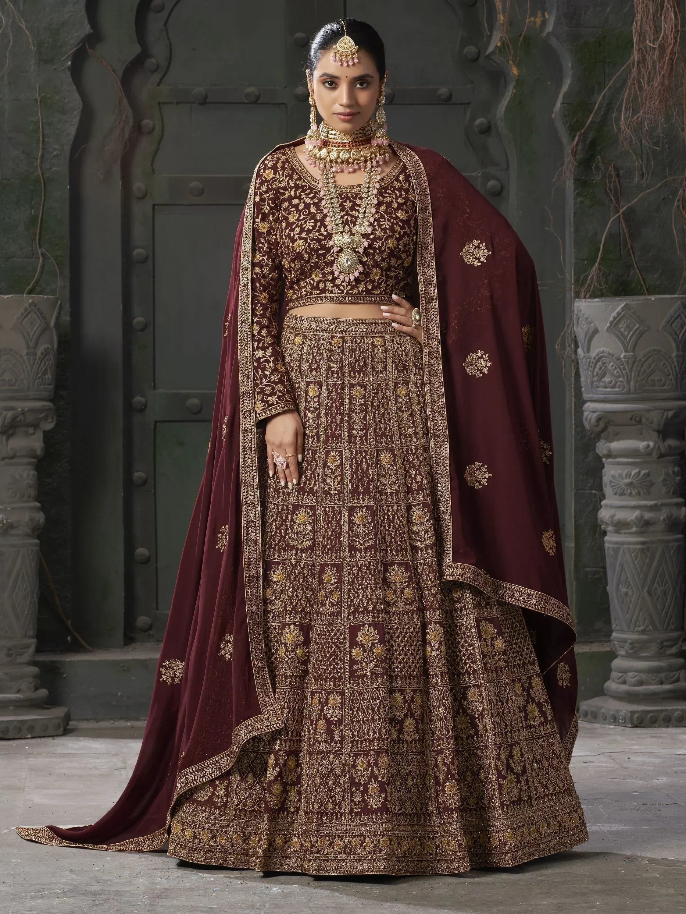 Maroon designer lehenga choli with gold embroidery, perfect for Indian weddings and ethnic events.