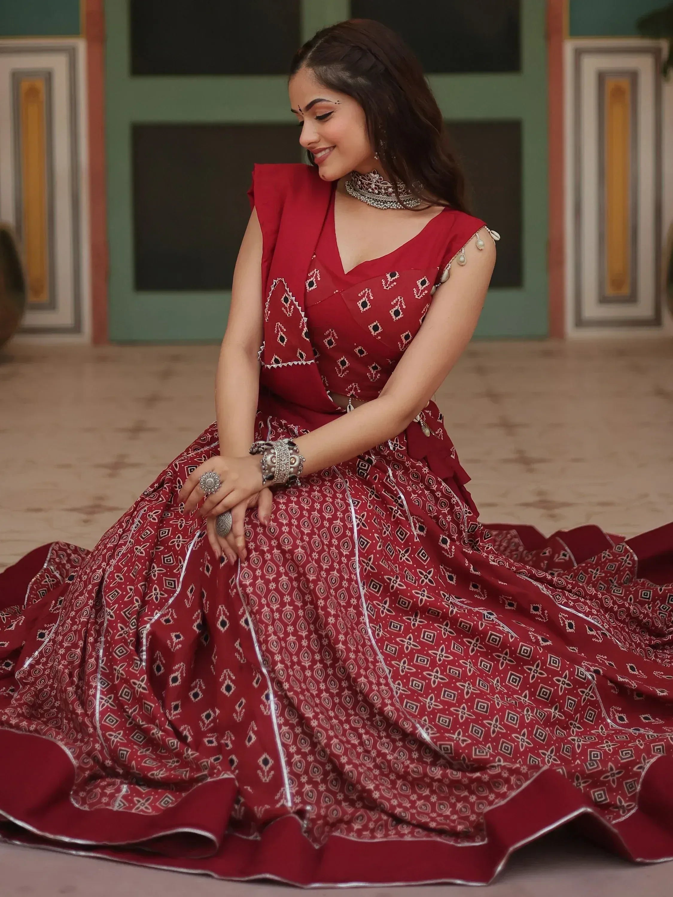 Woman in red printed lehenga choli with silver embroidery, ethnic Indian wear for festive occasions