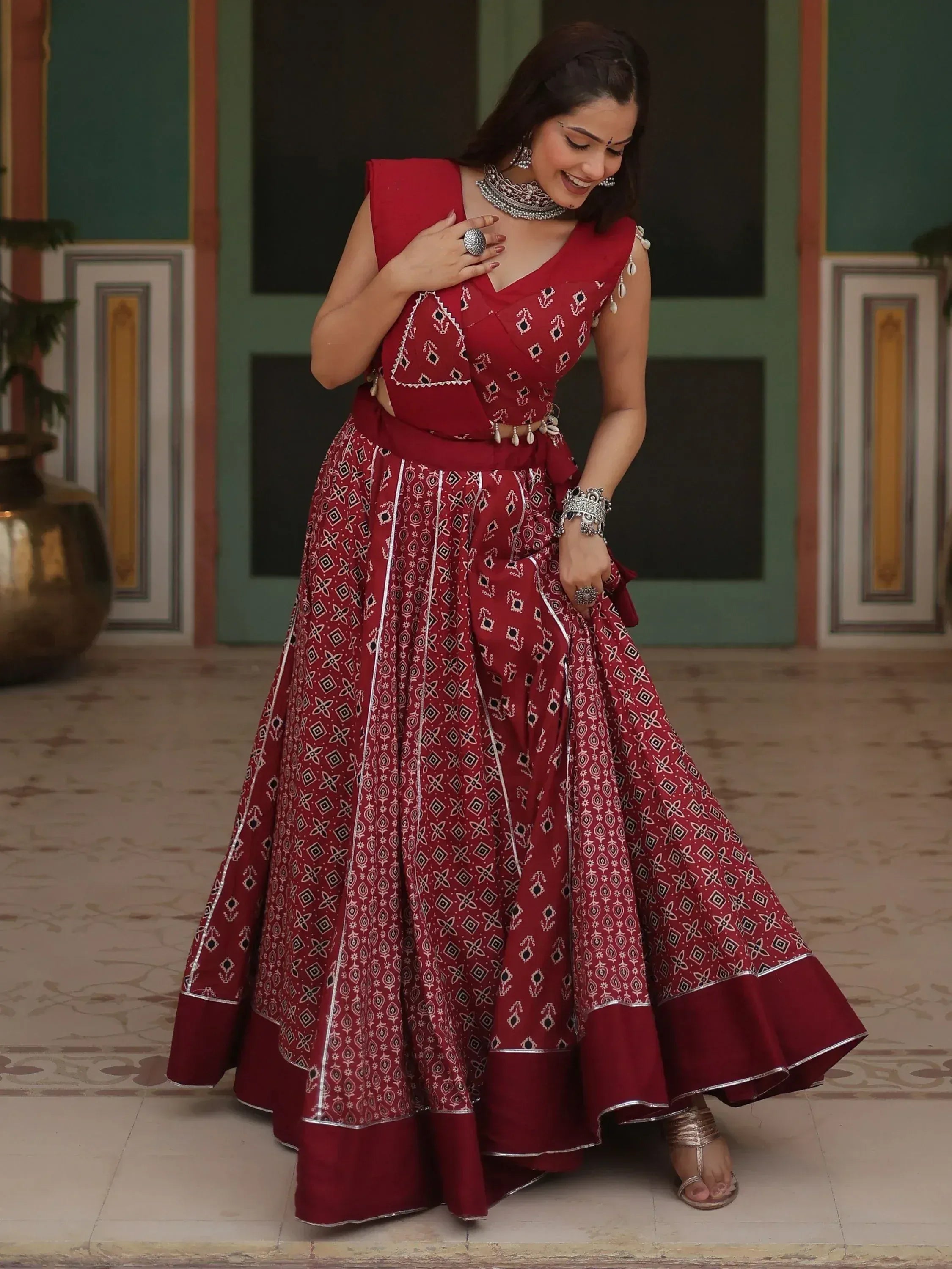 Red printed lehenga choli with silver embroidery, perfect for Indian ethnic wear and festive occasions.