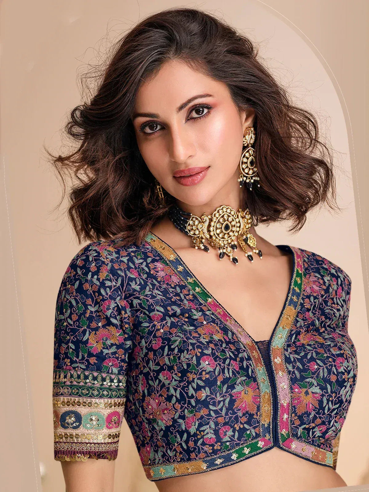 Floral embroidered navy blue designer blouse with gold jewelry for ethnic wear