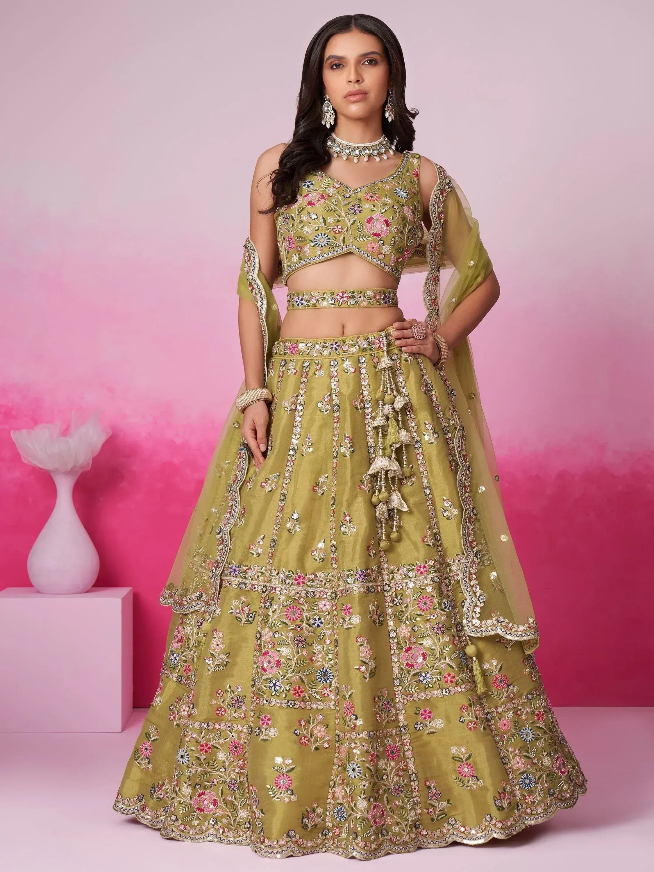 Olive green embroidered lehenga choli with floral motifs and tassels, perfect for Indian ethnic wear occasions.