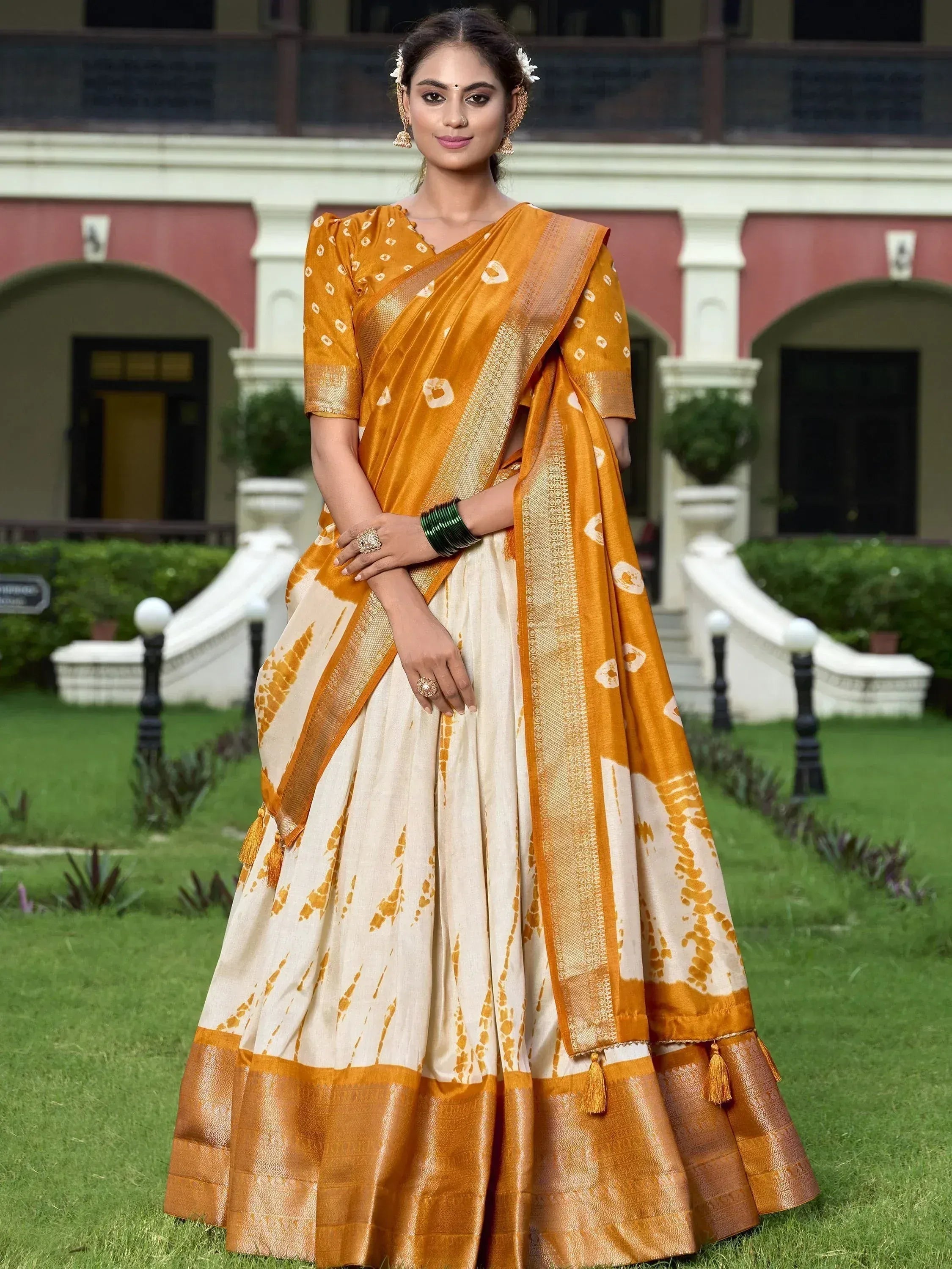 Woman in elegant mustard and cream saree with gold border, perfect for Indian ethnic occasions
