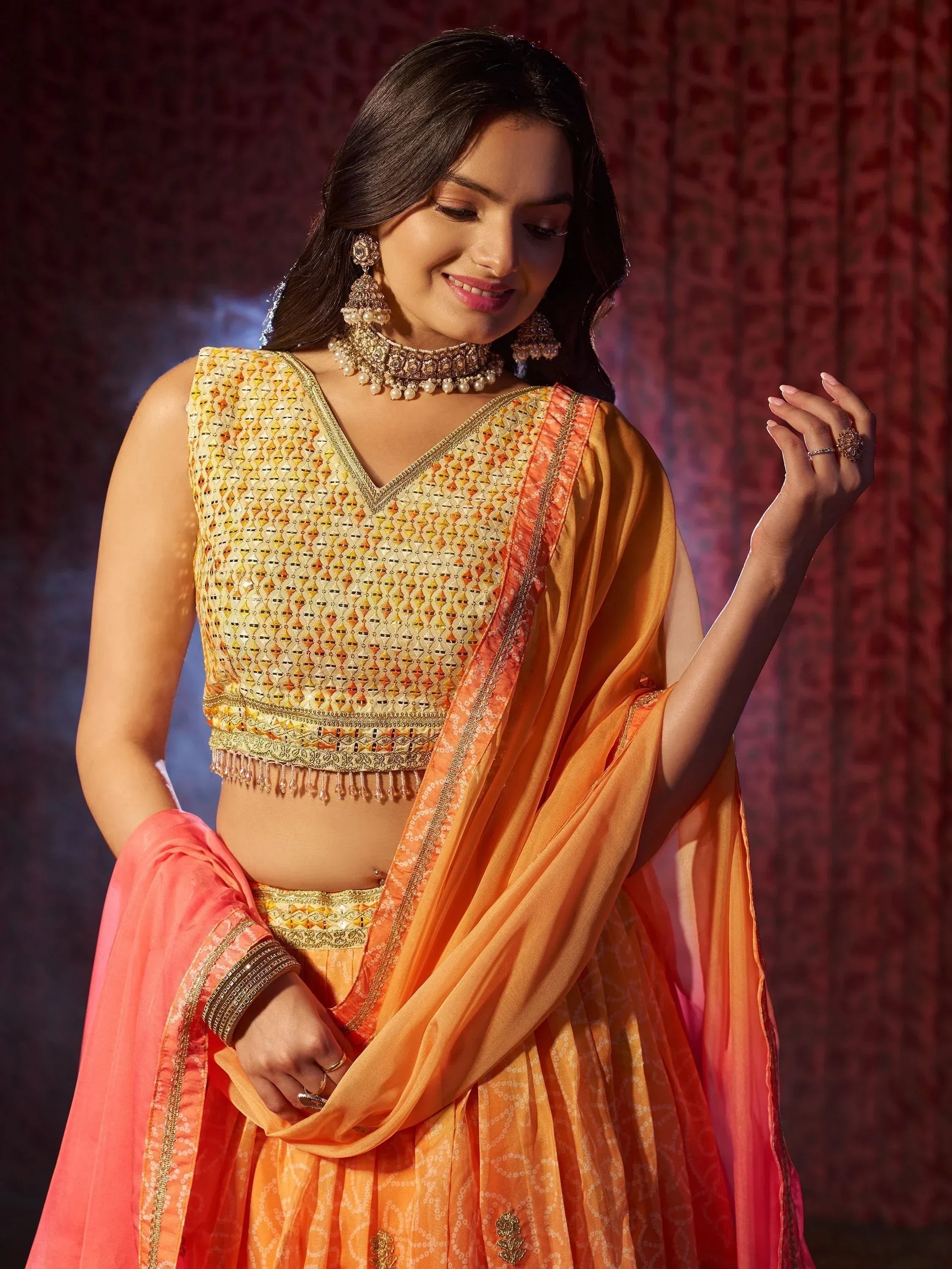 Orange and gold embroidered lehenga choli with dupatta, perfect for Indian ethnic wear and festive occasions.