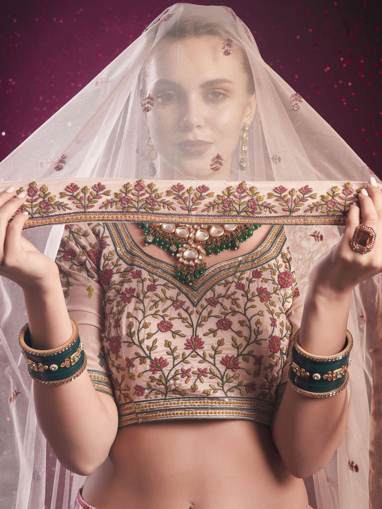 Elegant Indian bridal lehenga choli with floral embroidery, dupatta, and traditional jewelry