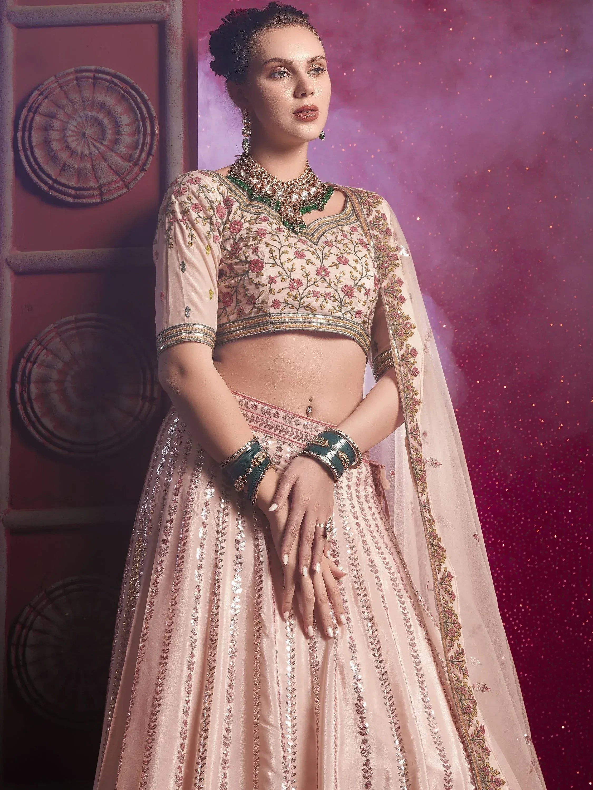 Elegant peach lehenga choli with floral embroidery and sequin detailing, perfect for Indian ethnic wear occasions.