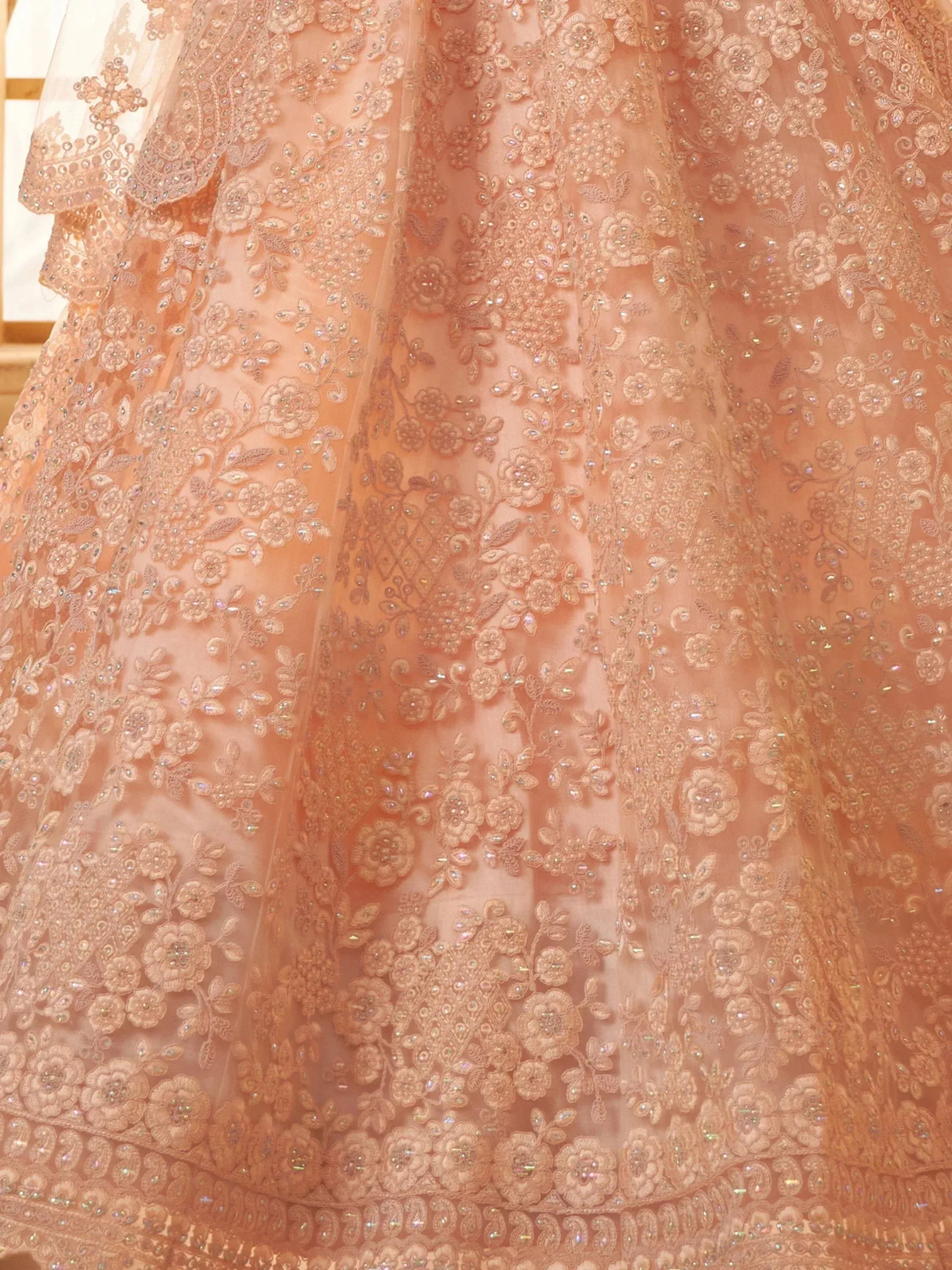 Peach floral embroidered lehenga with sequin detailing, perfect for Indian ethnic wear events.
