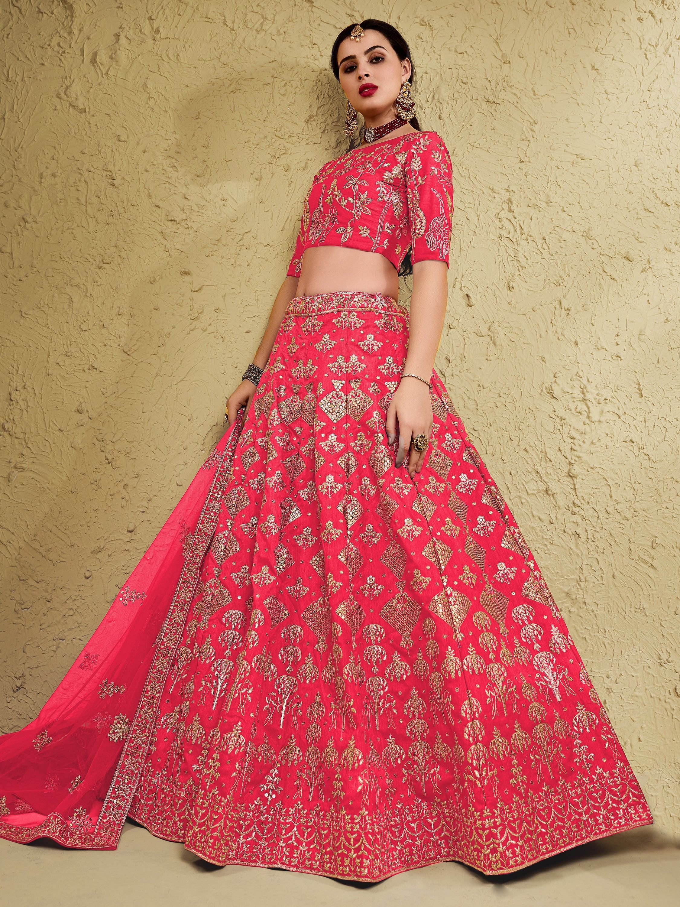 Red and gold embroidered lehenga choli with floral motifs, perfect for Indian weddings and festive occasions.