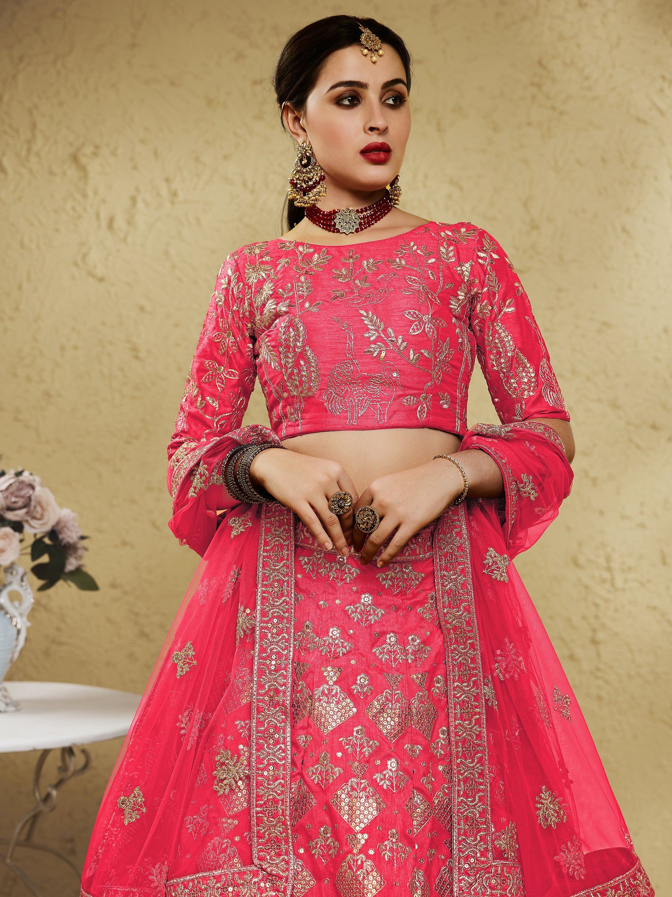 Pink embroidered lehenga choli with gold floral motifs, perfect for Indian weddings and festive occasions