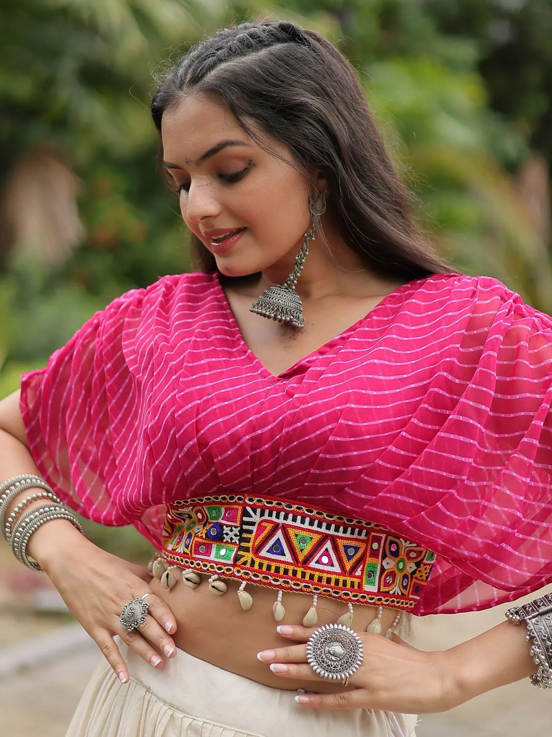 Pink ethnic crop top with mirror work, puff sleeves, and traditional jewelry for Indian wear