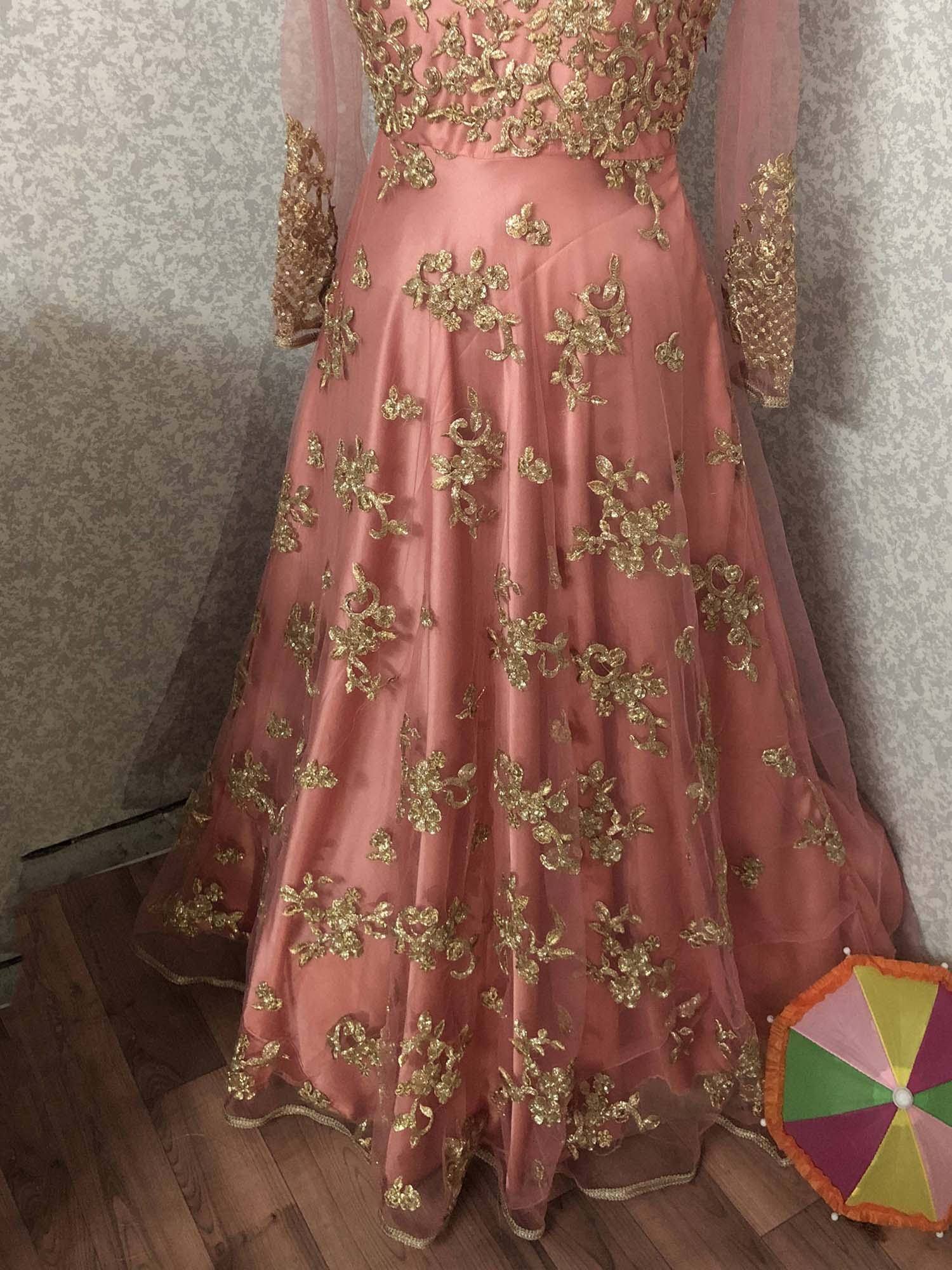 Pink designer lehenga choli with gold floral embroidery, perfect for Indian weddings and festive occasions.