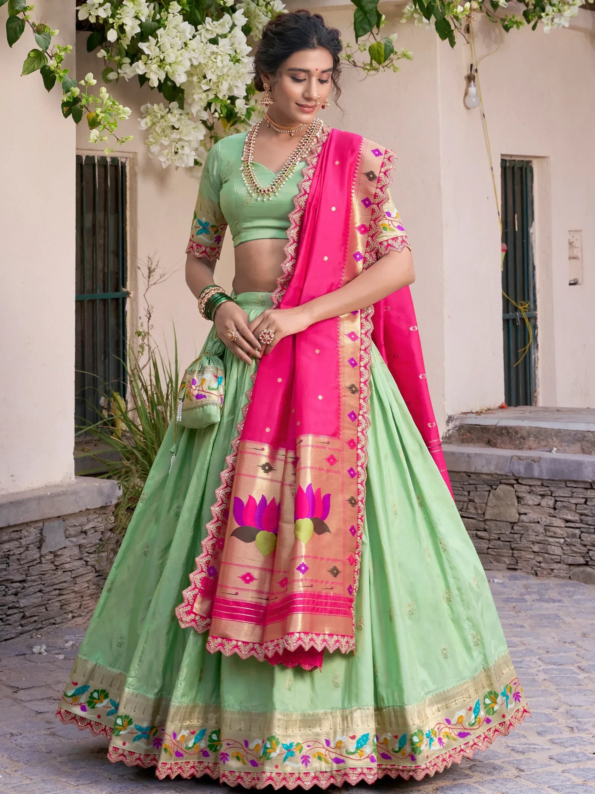 Green lehenga choli with pink dupatta, floral embroidery, and traditional Indian ethnic wear design