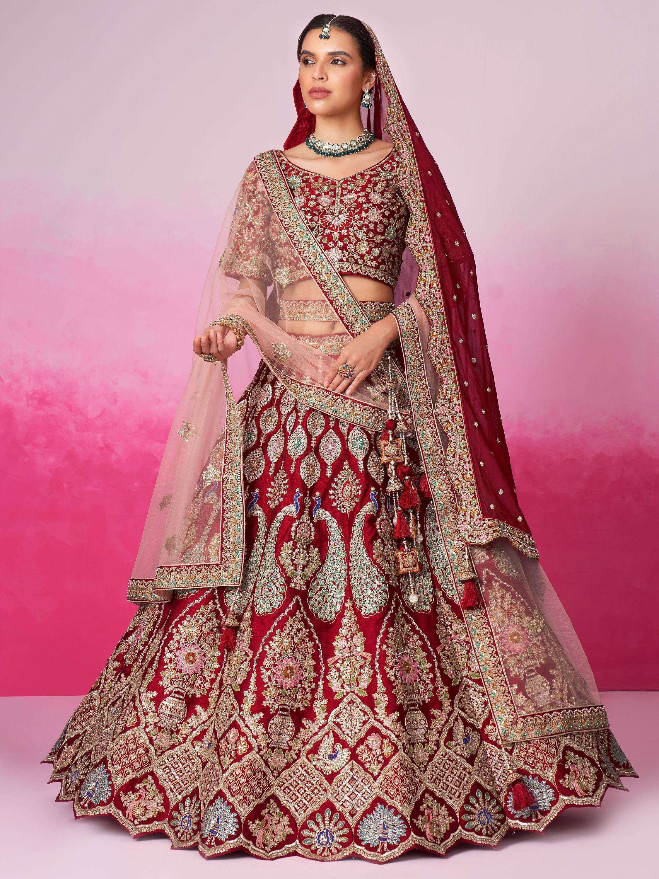 Maroon designer lehenga choli with heavy embroidery, peacock motifs, and sheer dupatta for Indian weddings