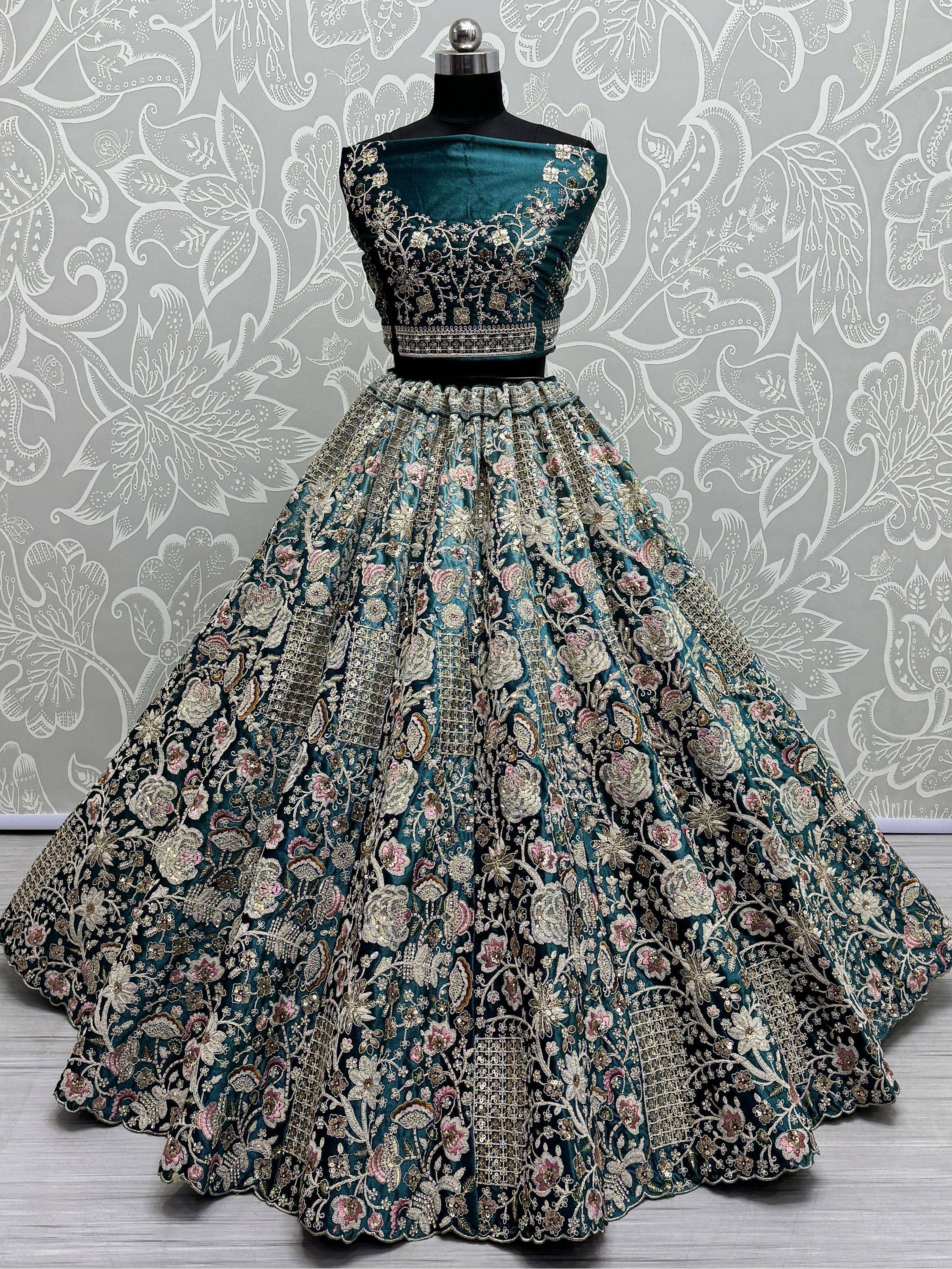 Teal velvet lehenga choli with intricate floral embroidery, perfect for Indian ethnic wear events.