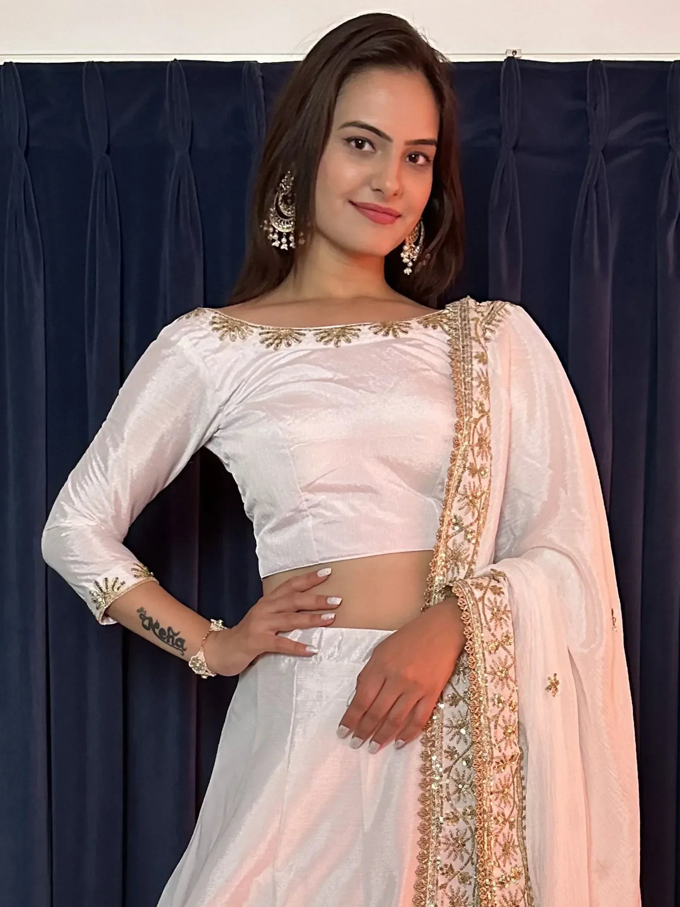 White velvet lehenga choli with gold embroidery, perfect for Indian ethnic wear and festive occasions.