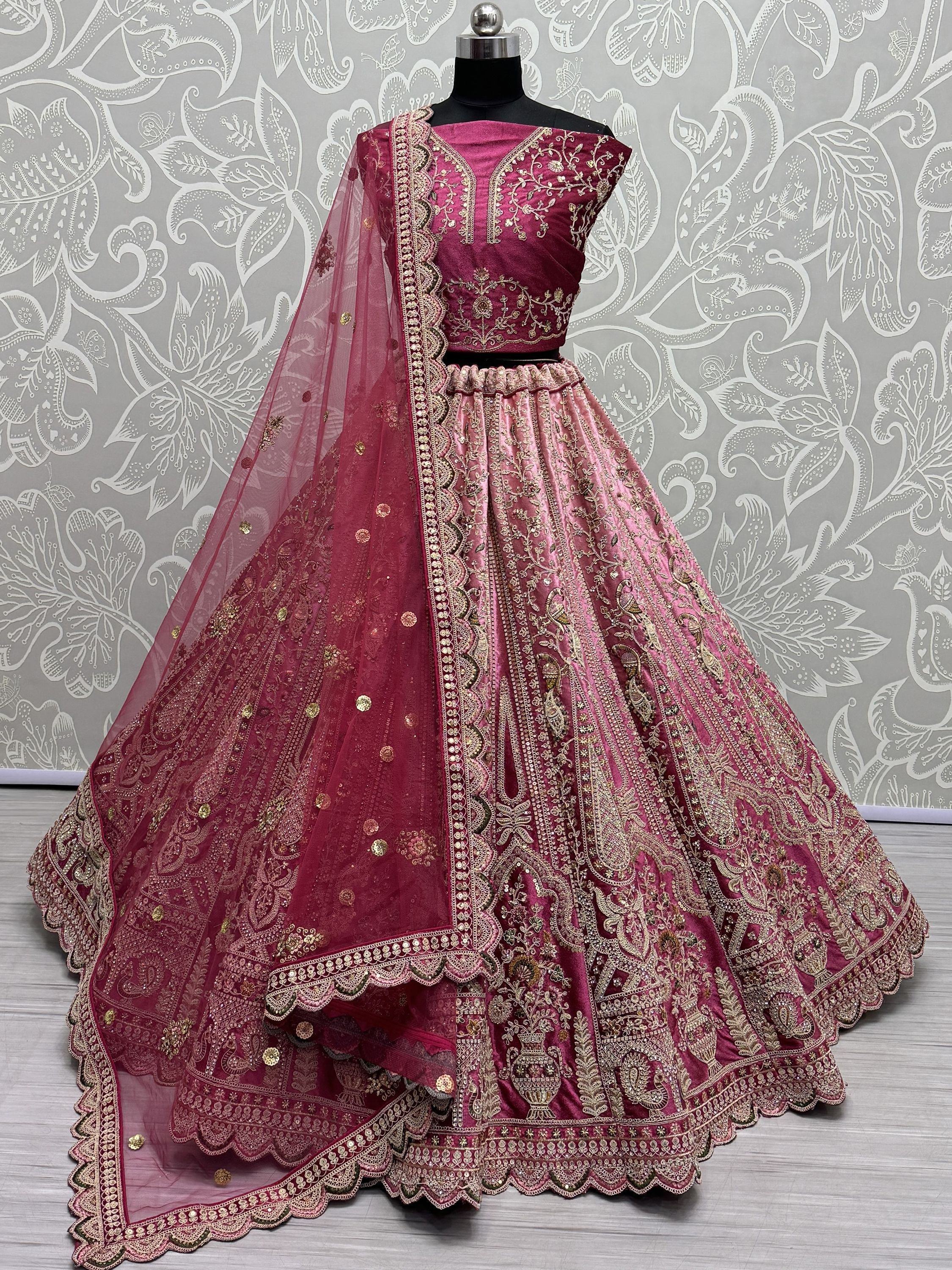 Elegant maroon lehenga choli with gold embroidery and sheer dupatta, perfect for Indian weddings and festive occasions.