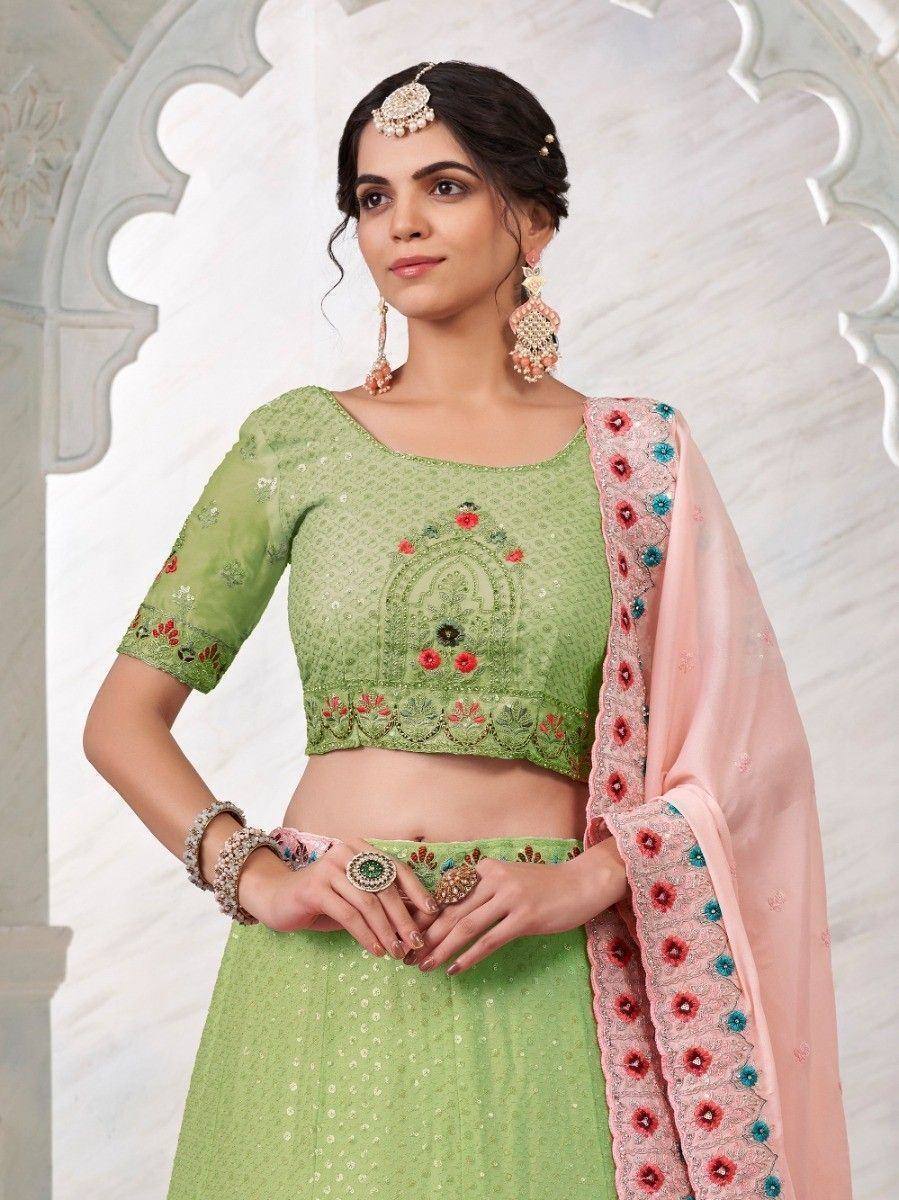 Green embroidered lehenga choli with pink floral dupatta, traditional Indian ethnic wear