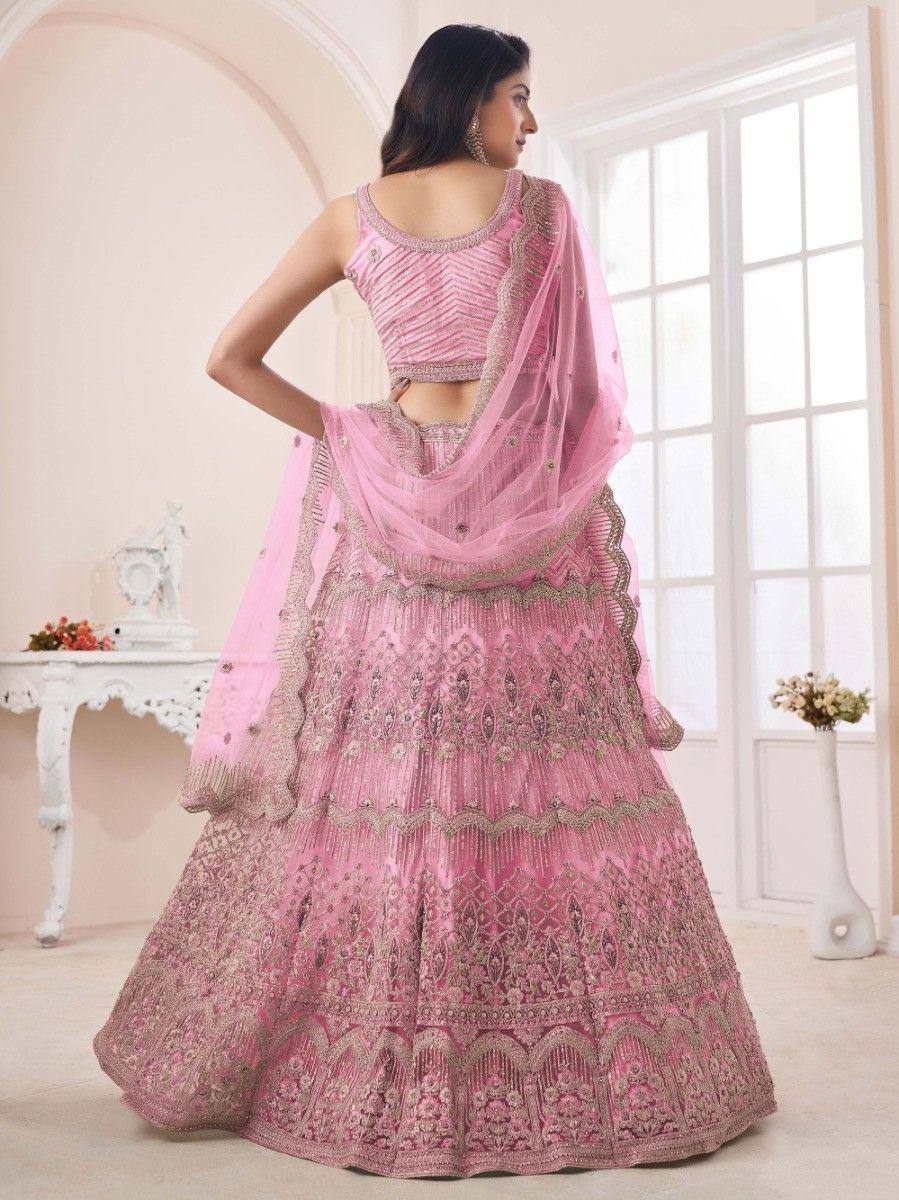 Pink embroidered lehenga choli with gold detailing, perfect for Indian weddings and festive occasions.