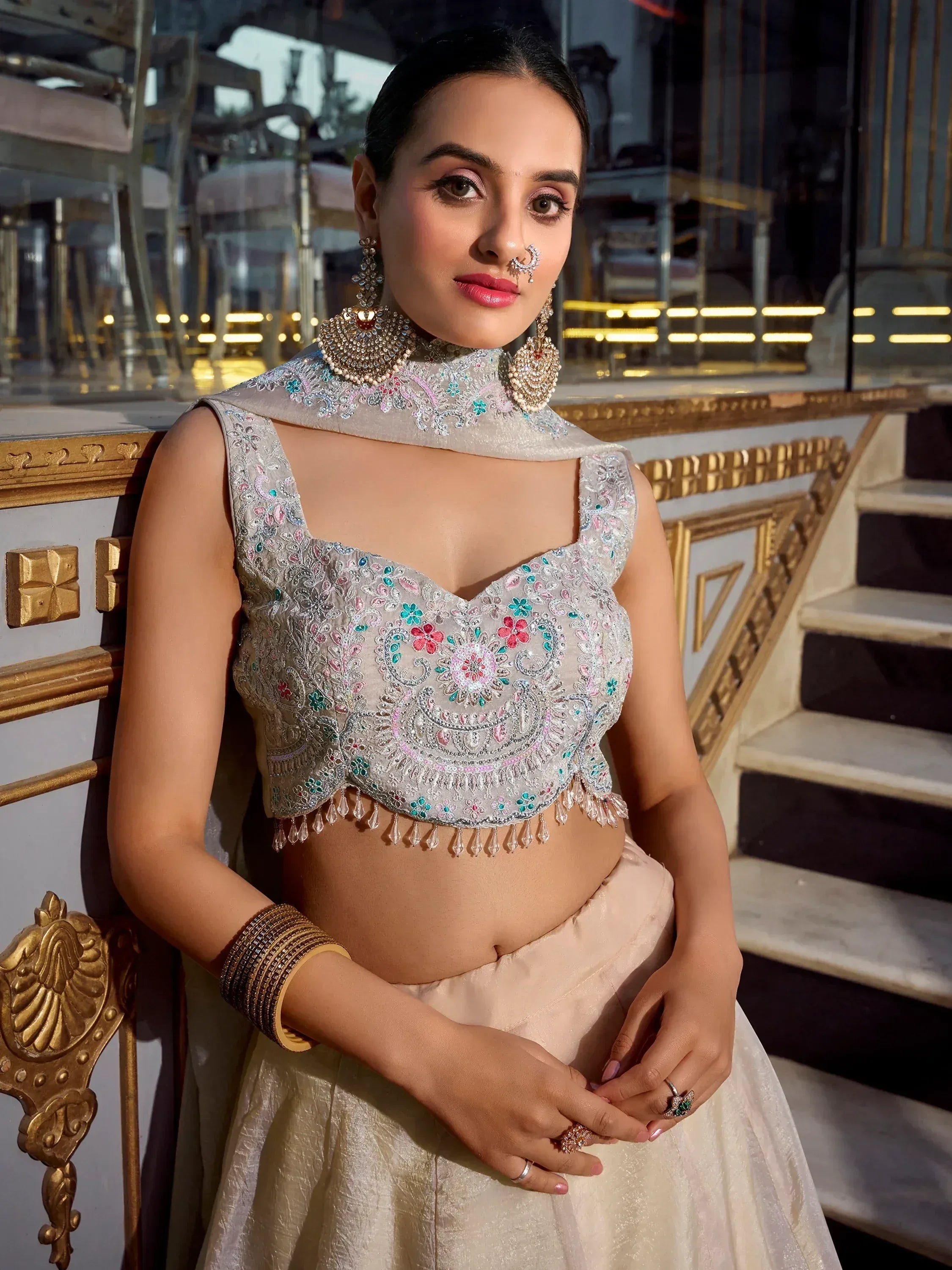 Elegant Indian ethnic wear with floral embroidered blouse and lehenga, perfect for weddings or festive occasions.