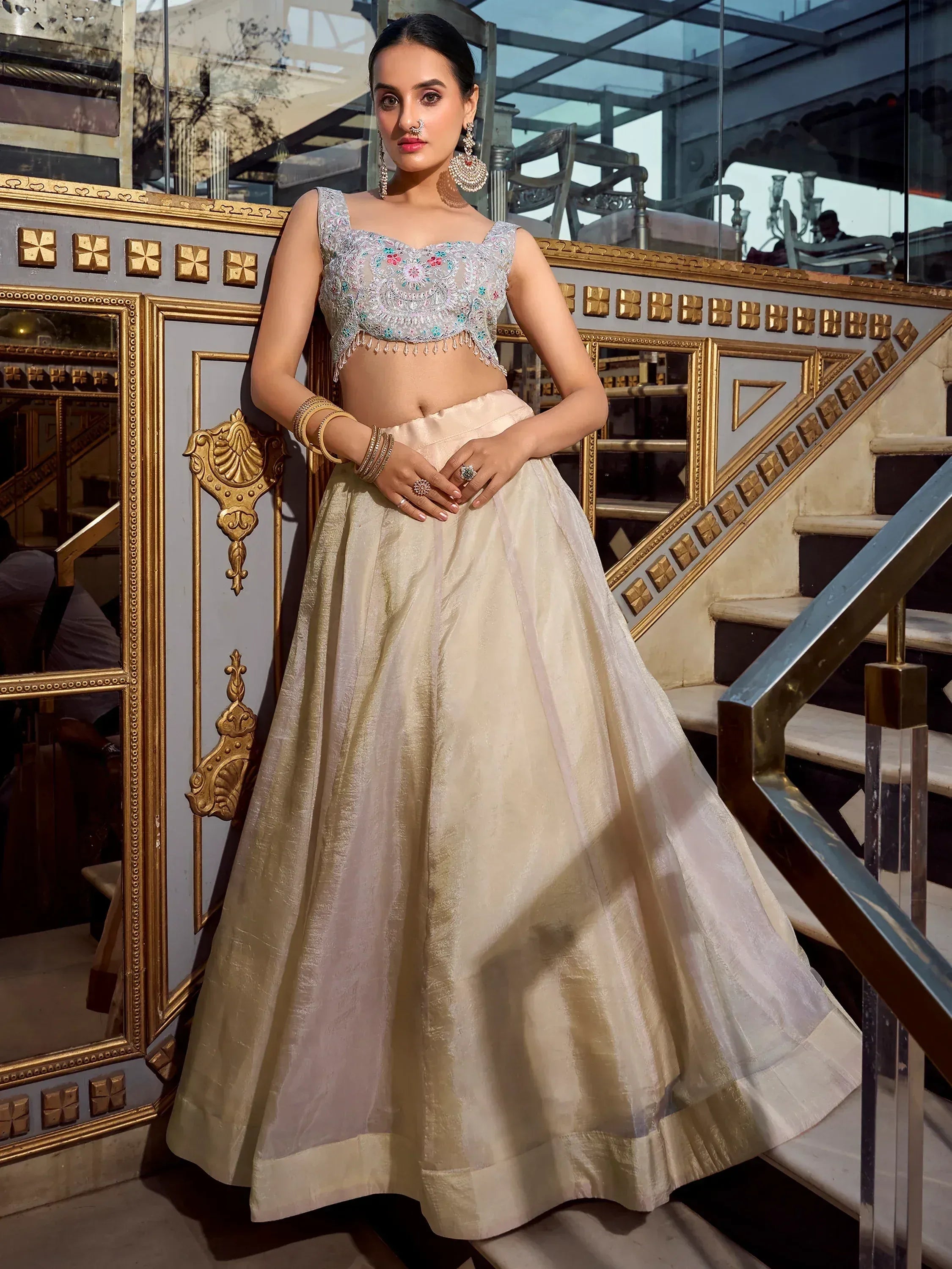 Elegant ivory lehenga choli with floral embroidered blouse, perfect for Indian weddings and festive occasions.