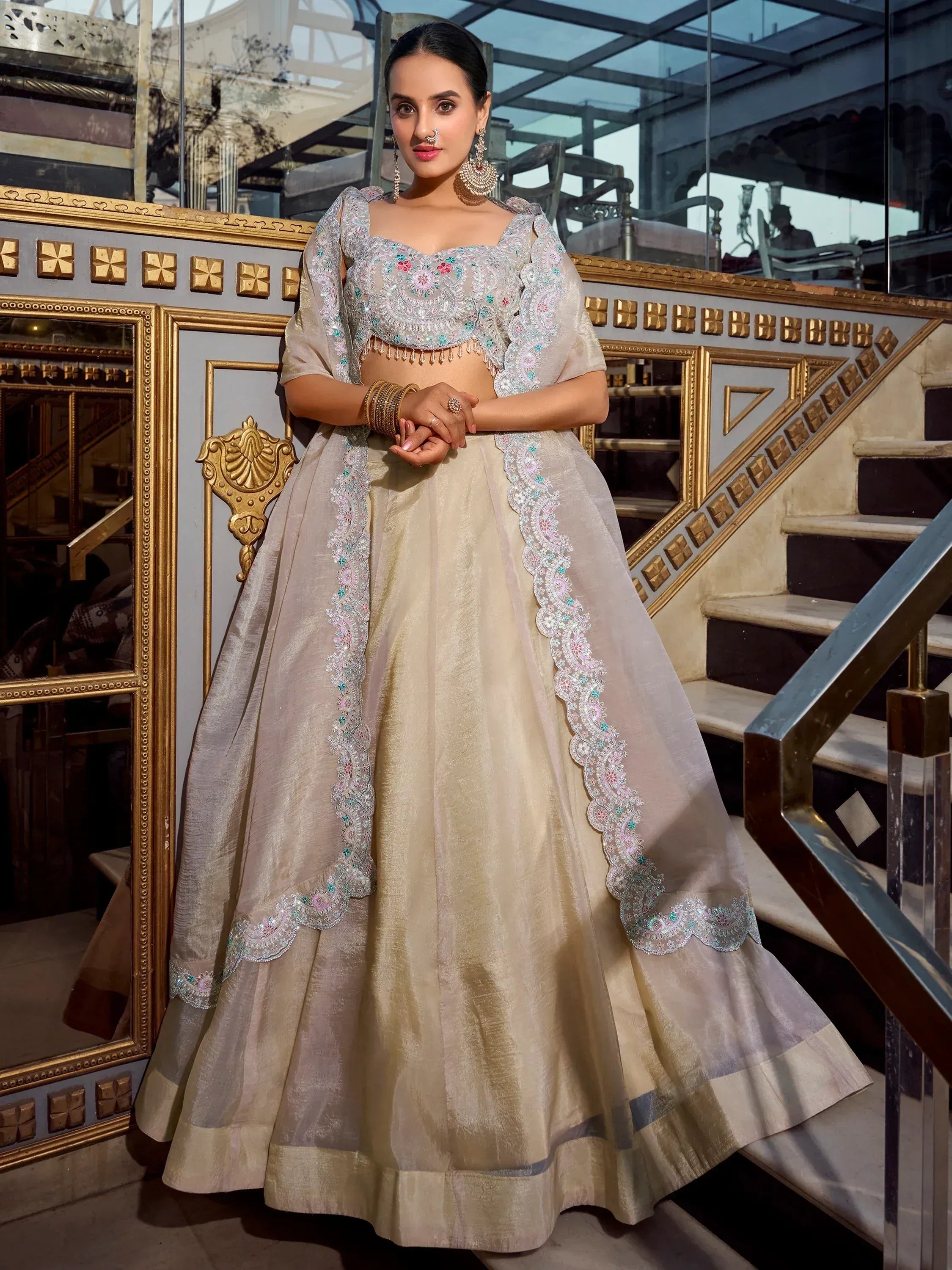 Elegant beige lehenga choli with floral embroidery, perfect for Indian weddings and festive occasions.