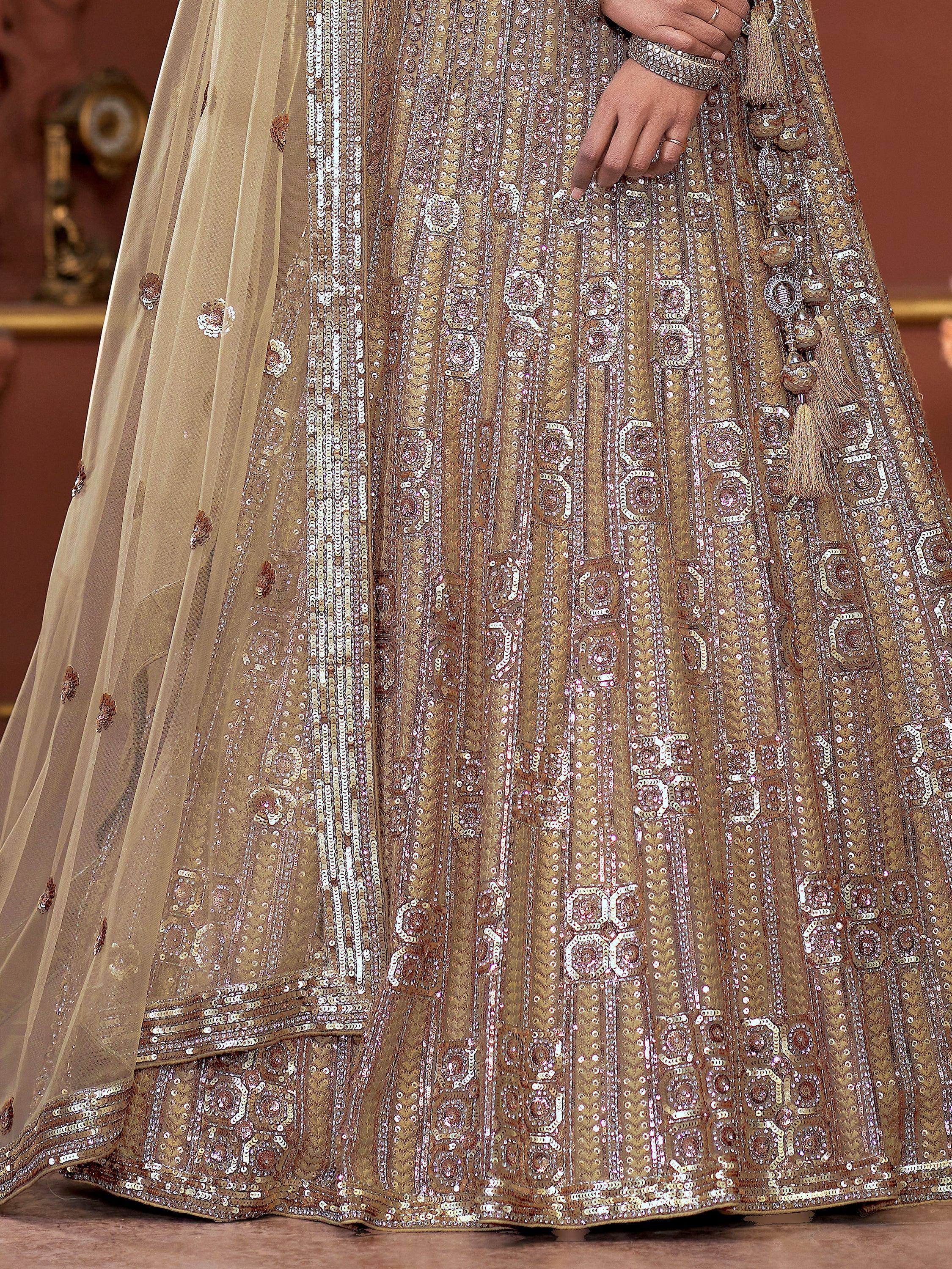 Gold sequin embroidered lehenga choli with sheer dupatta, perfect for Indian weddings and festive occasions.