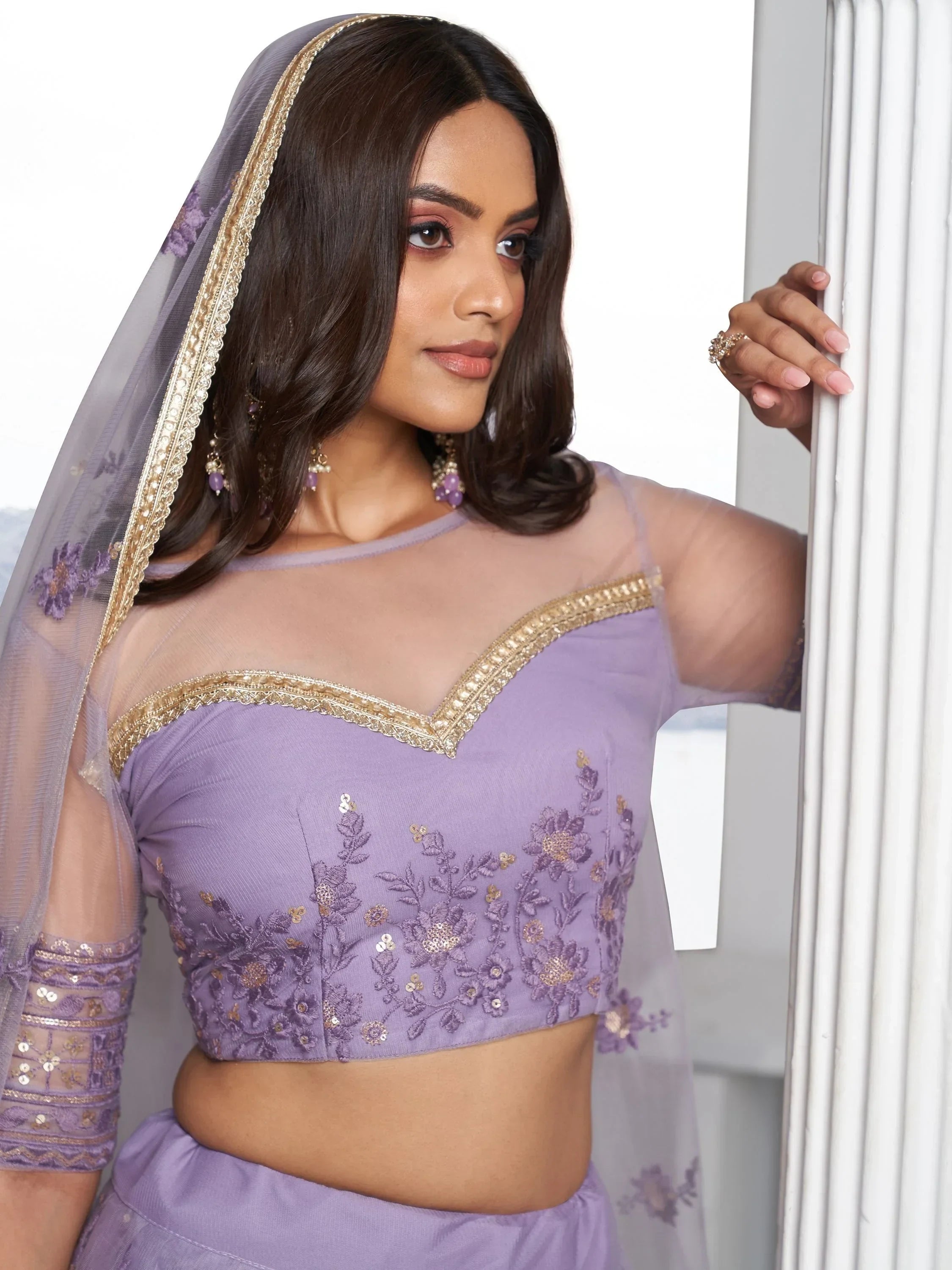 Lavender ethnic lehenga choli with gold embroidery and sheer dupatta, perfect for Indian weddings and festive occasions.