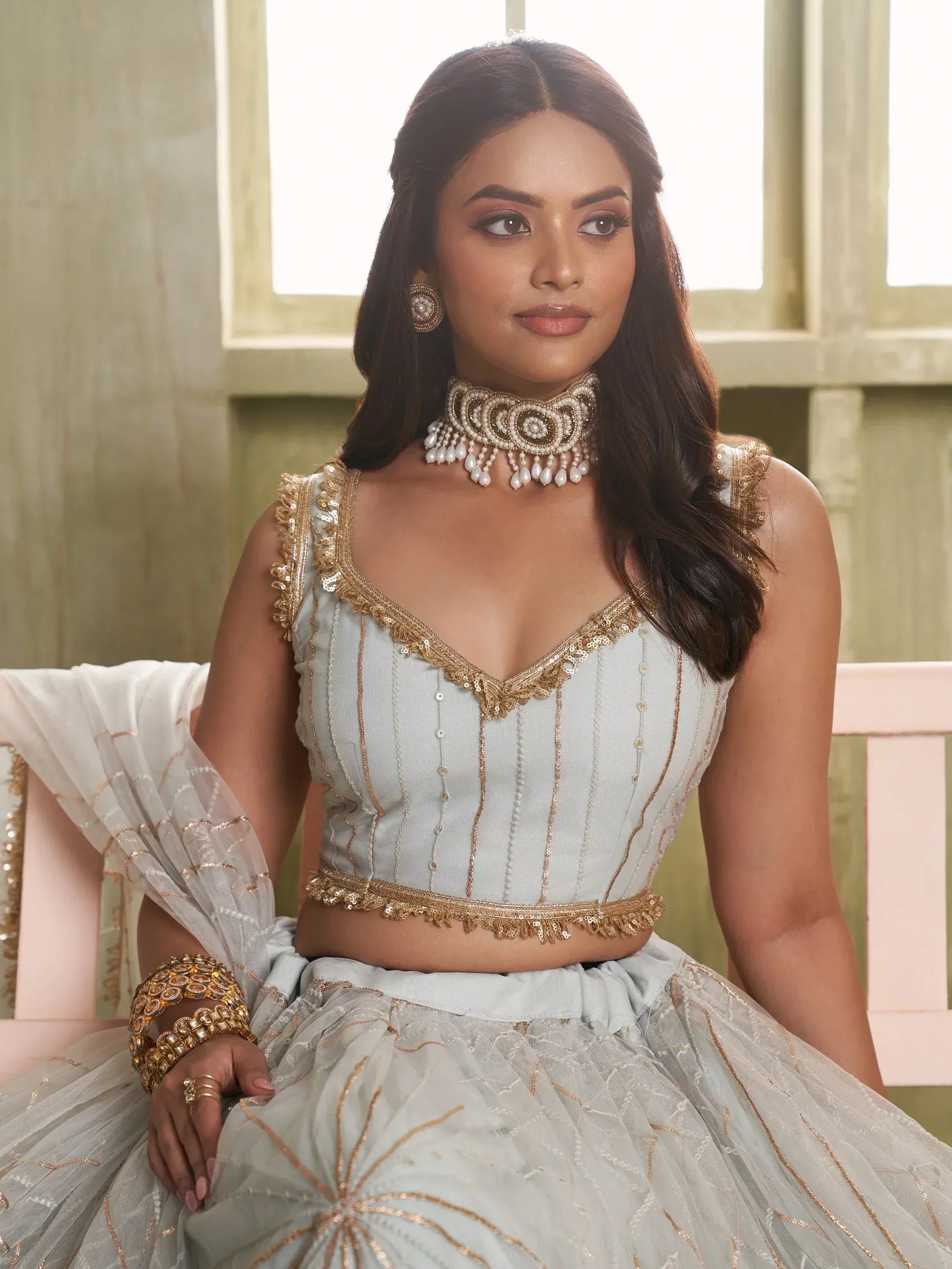 Elegant light blue lehenga choli with gold embroidery, perfect for Indian ethnic wear events.