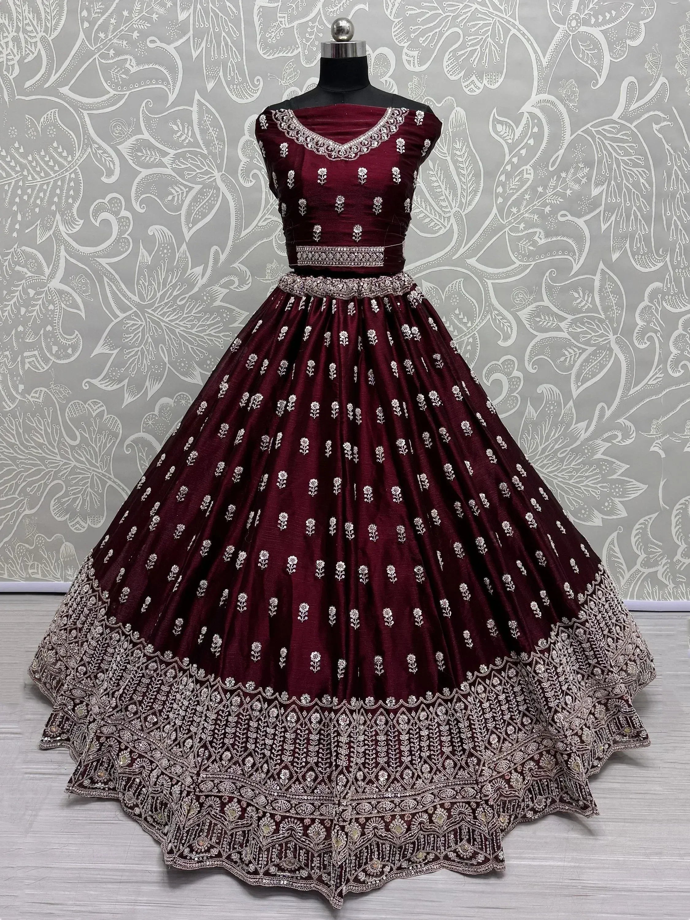 Burgundy designer lehenga choli with silver floral embroidery and heavy border, perfect for weddings and parties