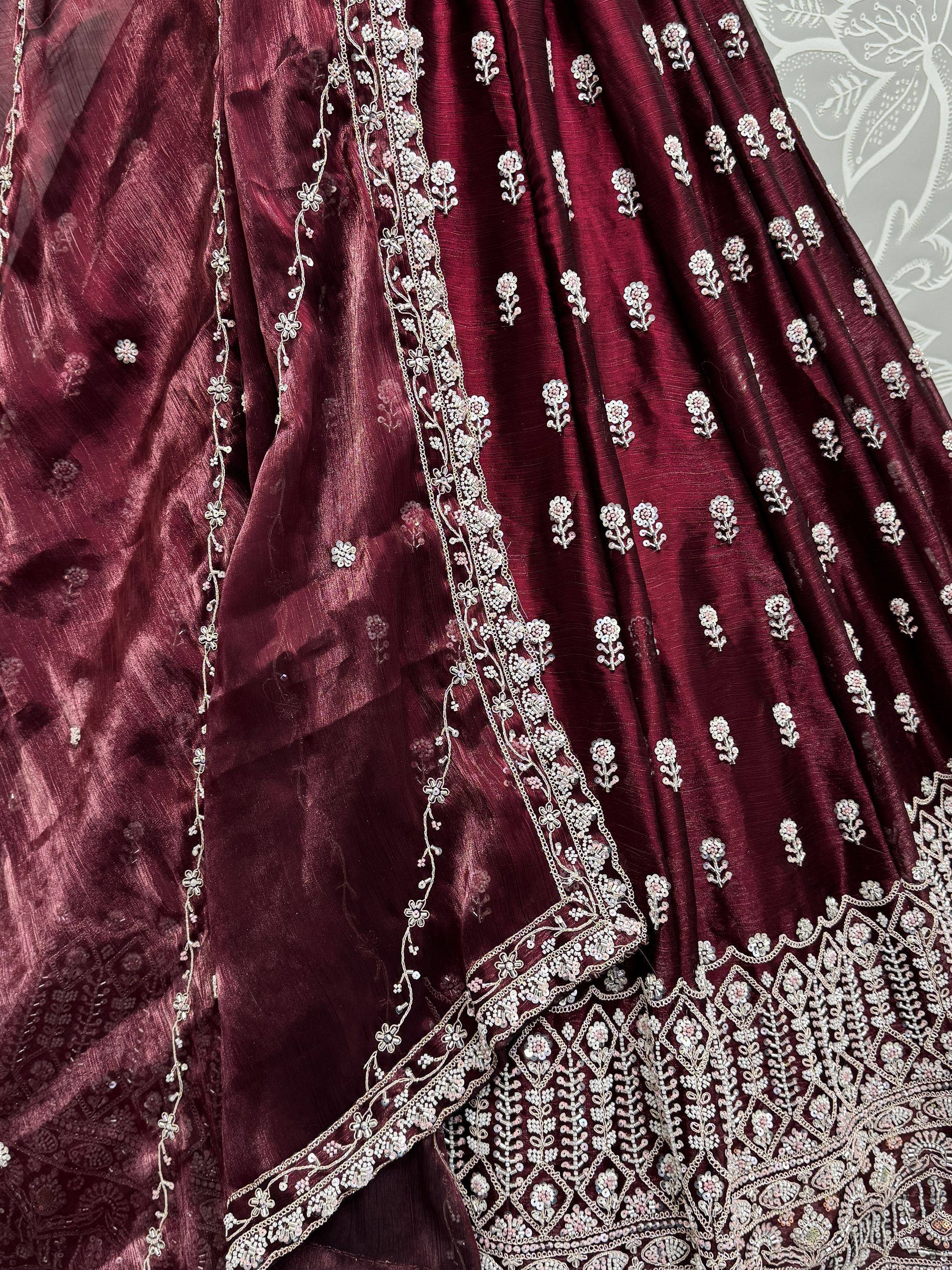 Burgundy lehenga with intricate silver floral embroidery and sequin detailing, perfect for Indian ethnic wear.