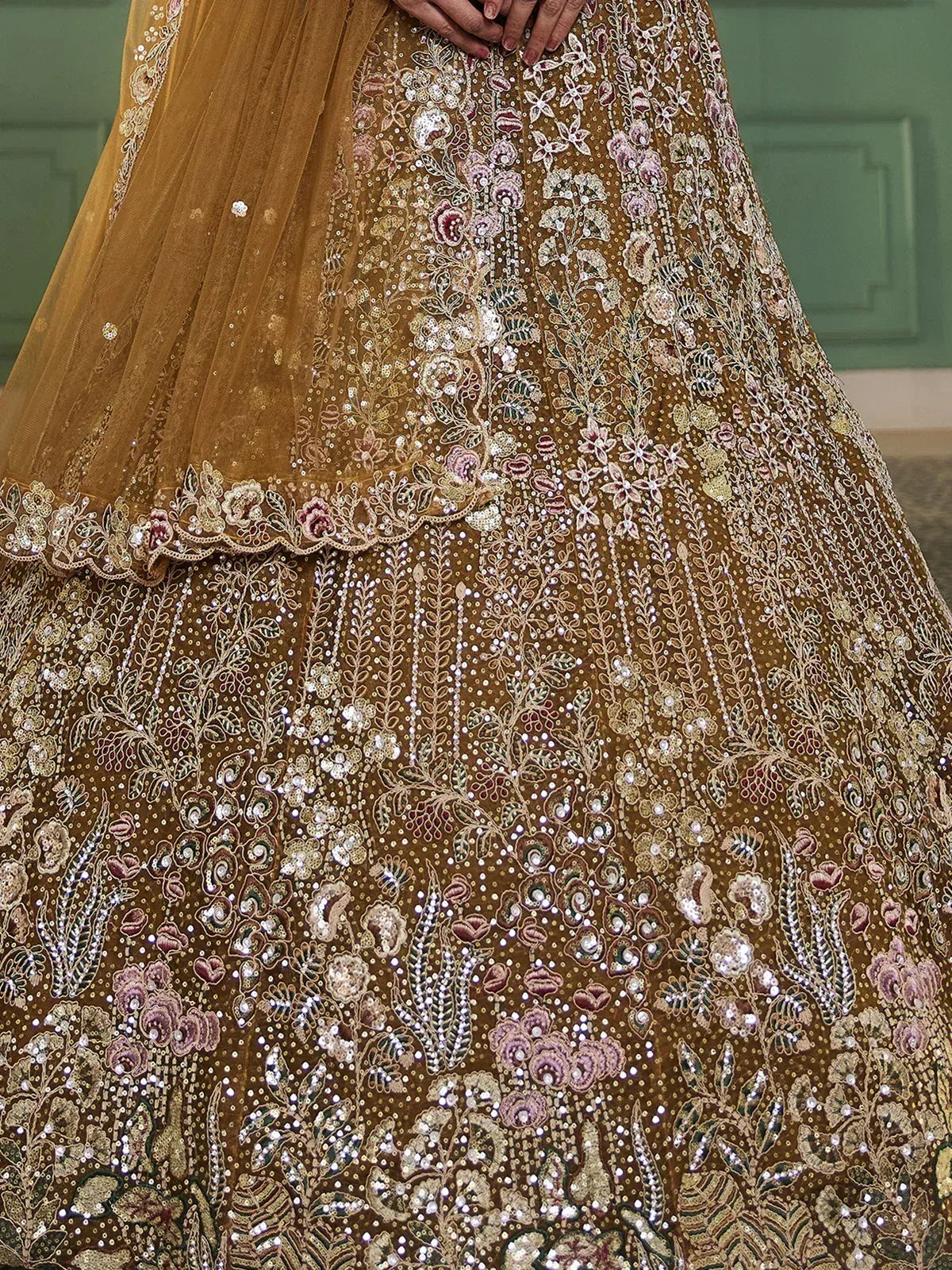 Golden lehenga choli with intricate floral embroidery and sequin work, perfect for Indian ethnic wear