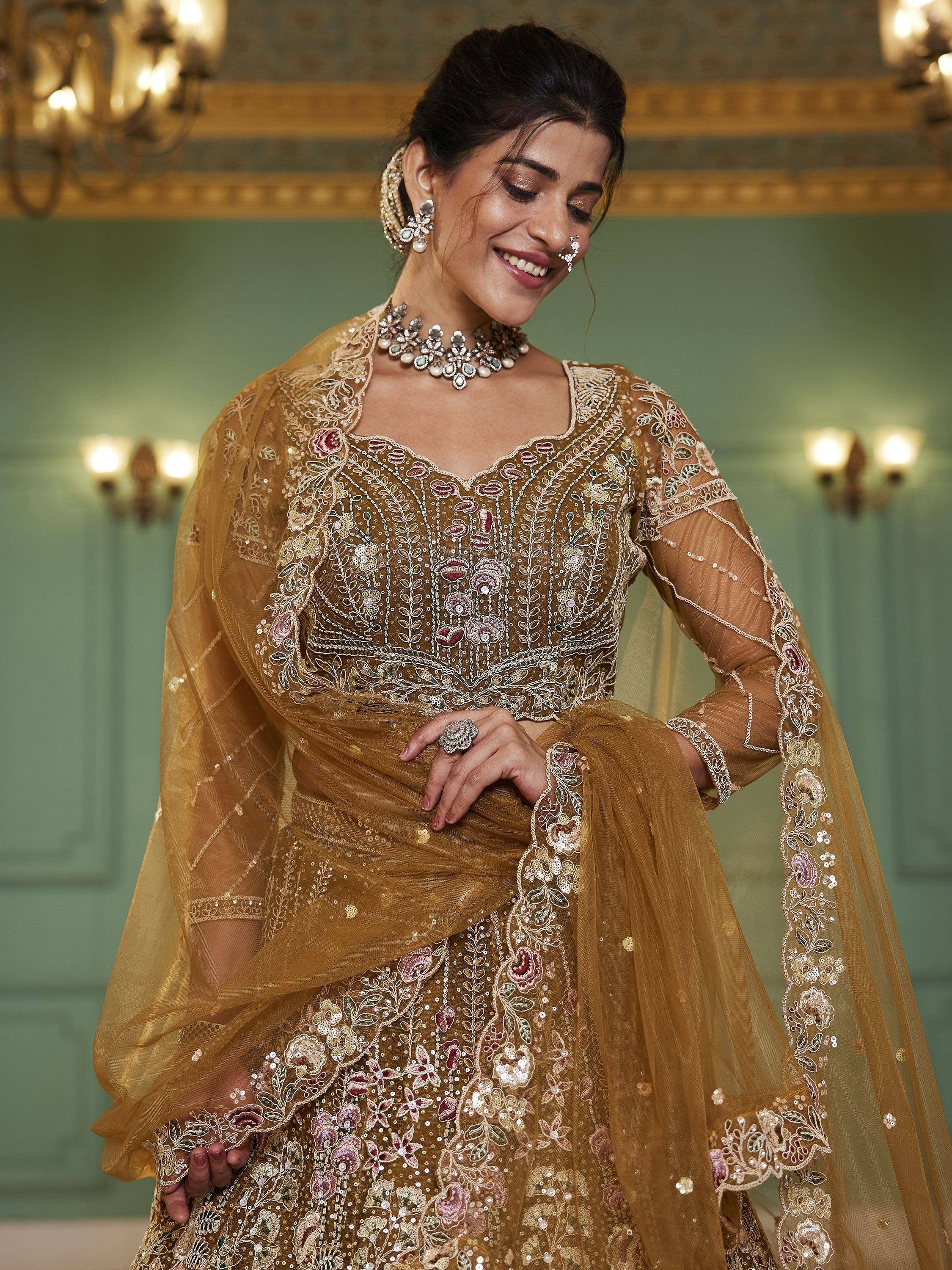 Elegant gold embroidered lehenga choli with floral motifs, perfect for Indian weddings and festive occasions.