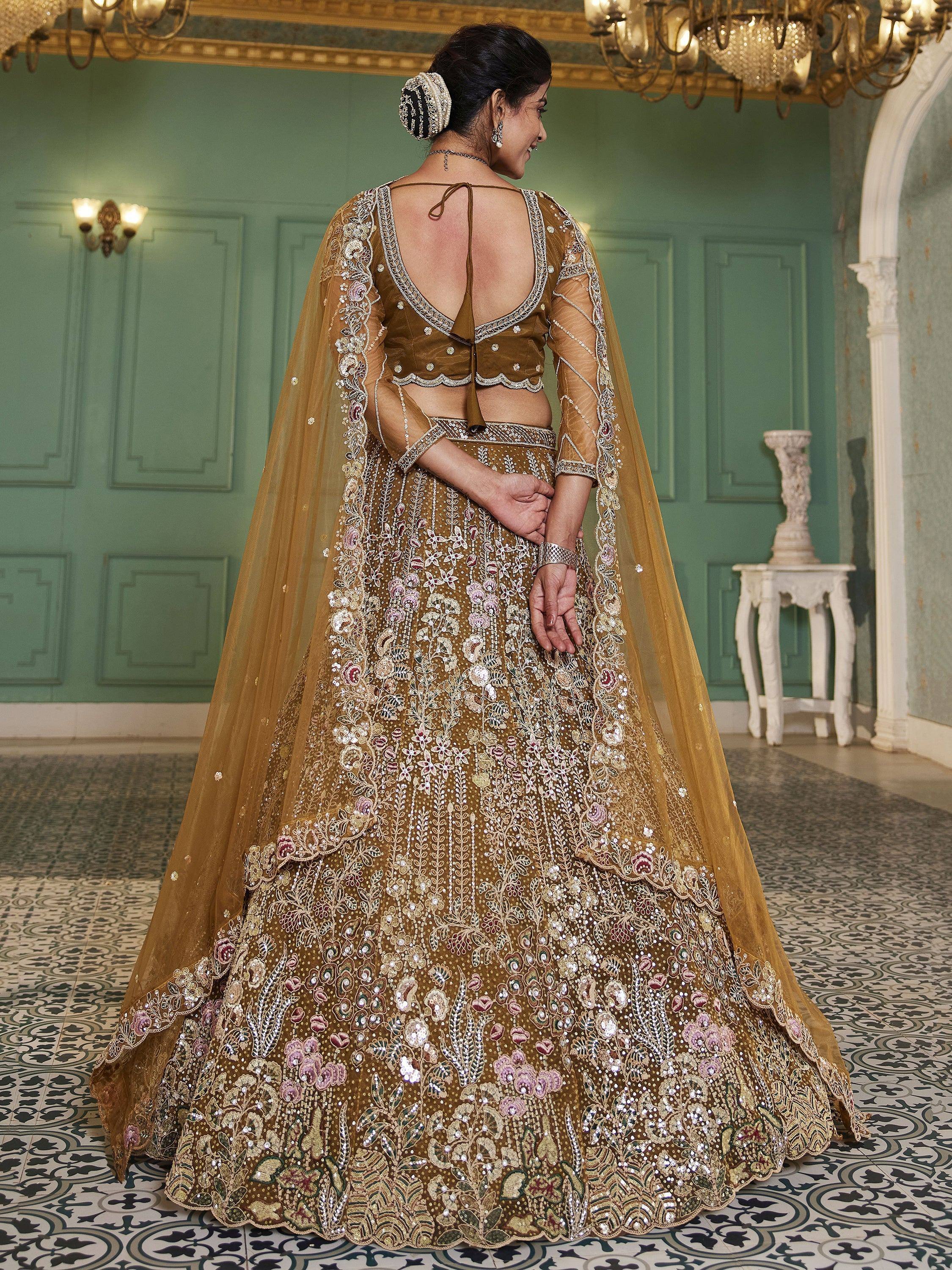 Elegant mustard lehenga choli with floral embroidery and sheer cape, perfect for Indian weddings and festive occasions.