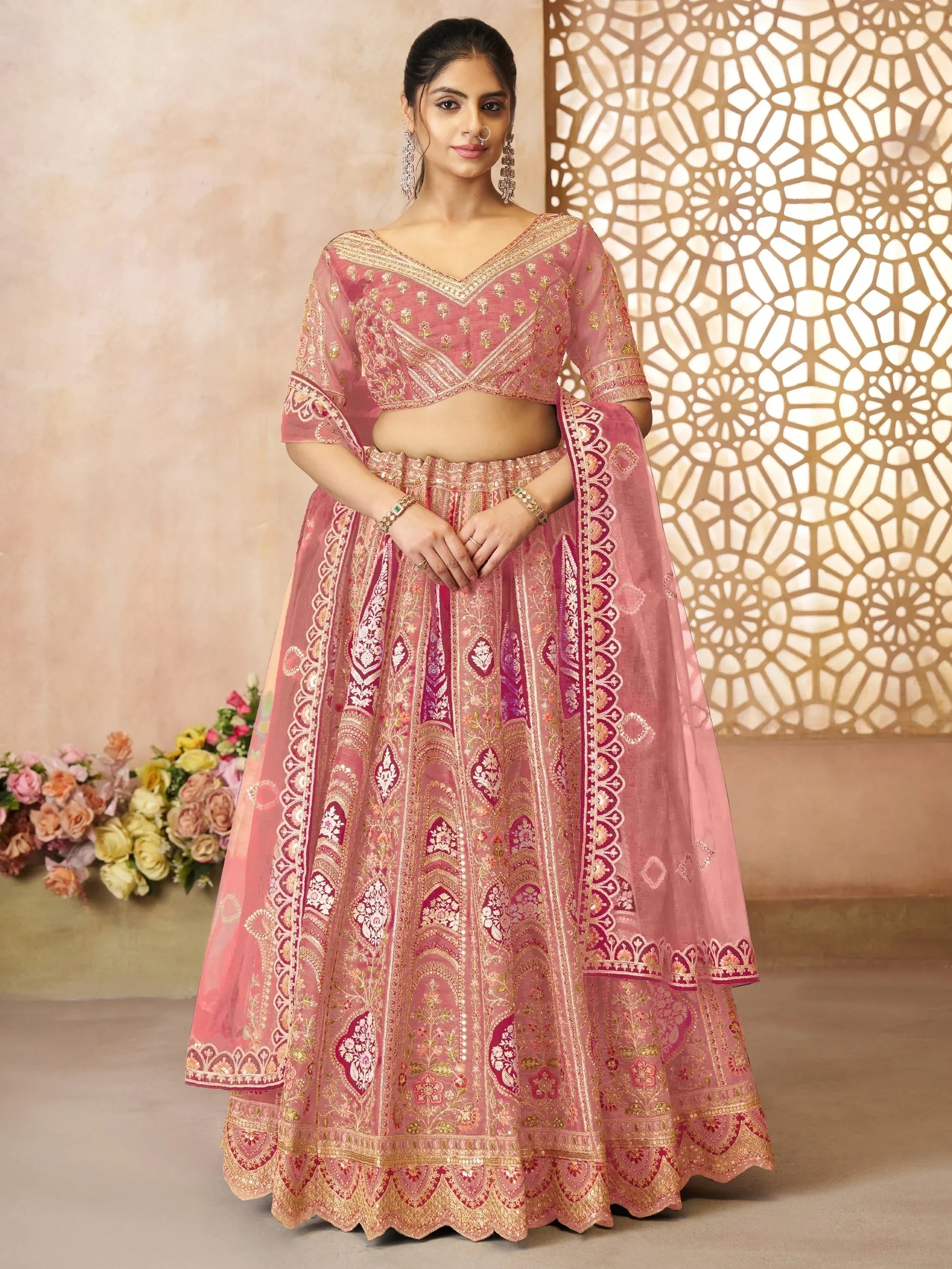Pink embroidered lehenga choli with gold detailing, perfect for Indian weddings and festive occasions.