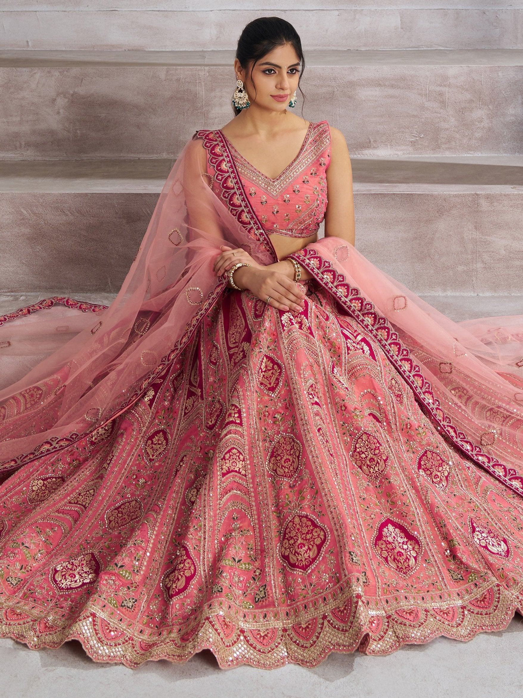 Pink embroidered lehenga choli with heavy gold detailing, perfect for Indian weddings and festive occasions.