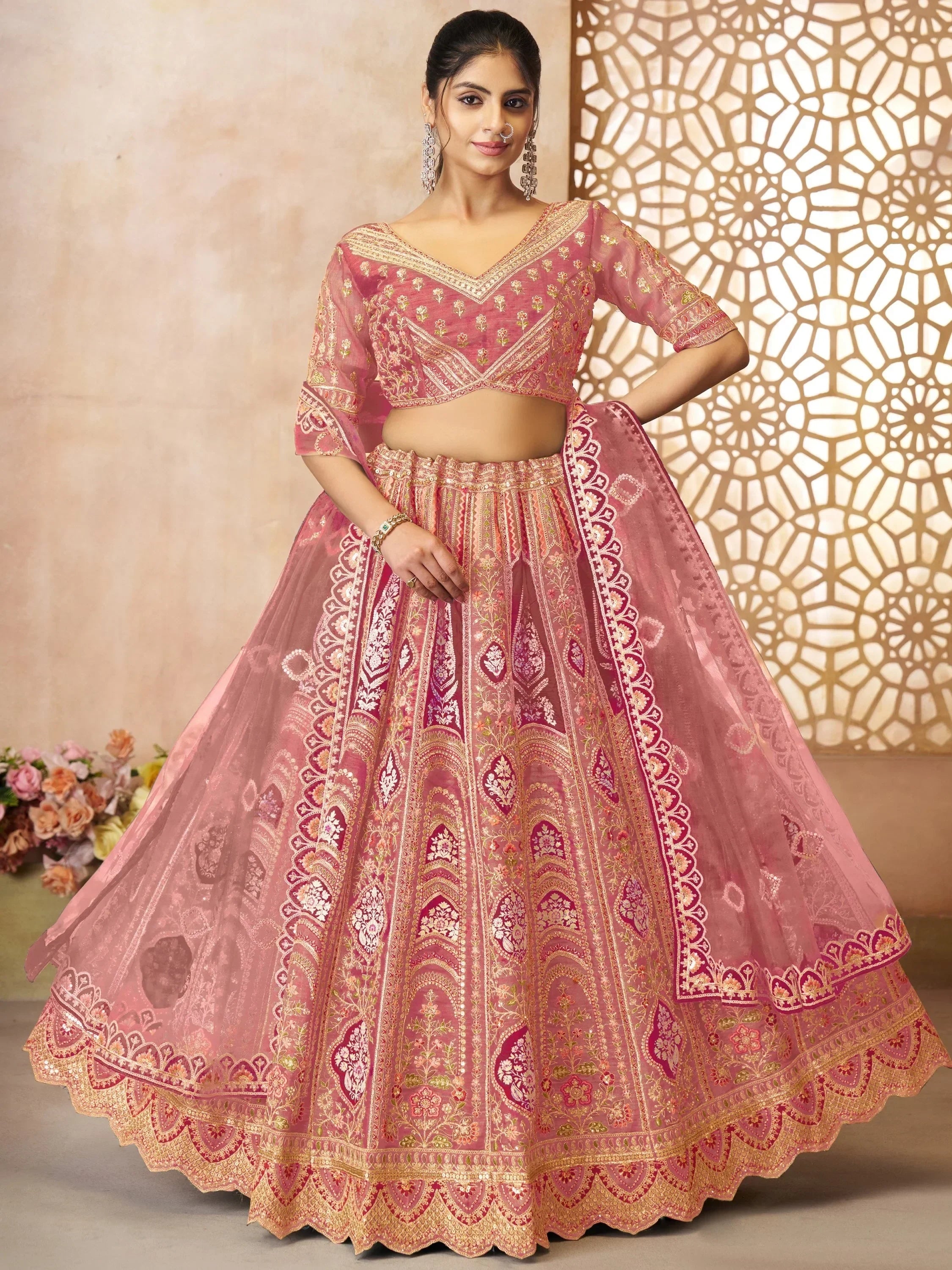 Pink embroidered lehenga choli with gold detailing, perfect for Indian weddings and festive occasions.