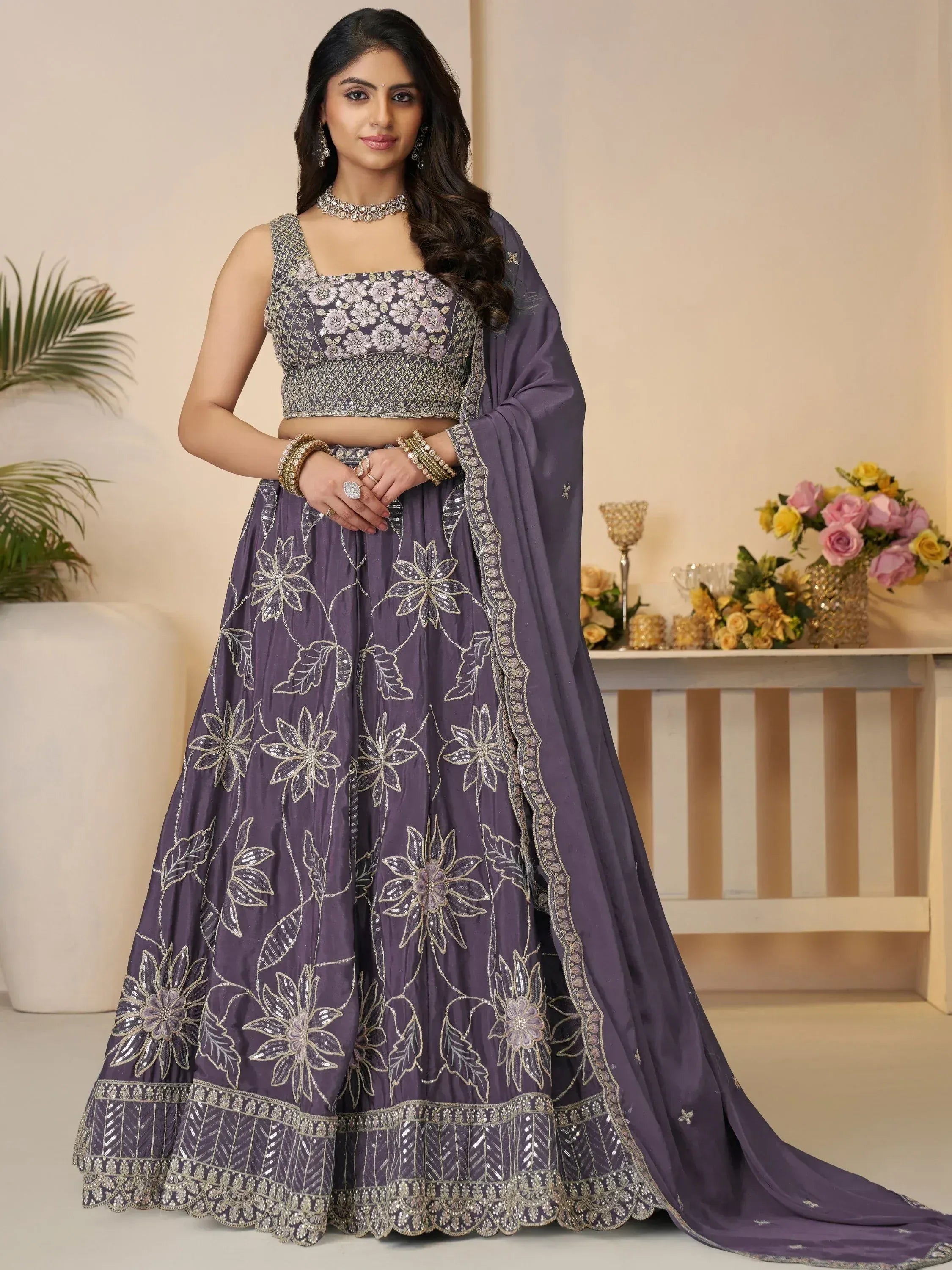 Purple floral embroidered lehenga choli with matching dupatta, perfect for Indian weddings and festive occasions.