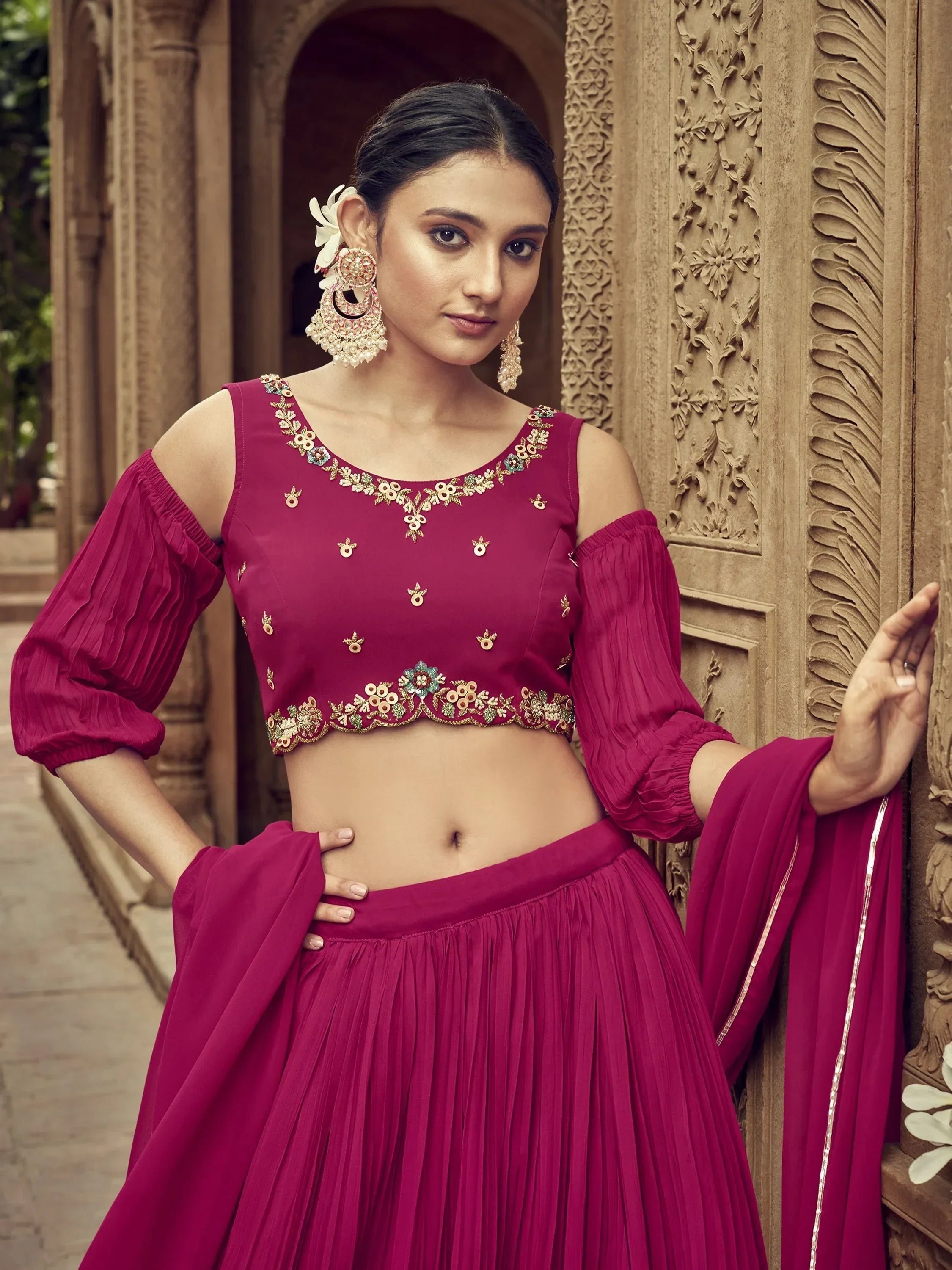 Magenta designer lehenga choli with floral embroidery, cold shoulder top, and pleated skirt for Indian ethnic wear