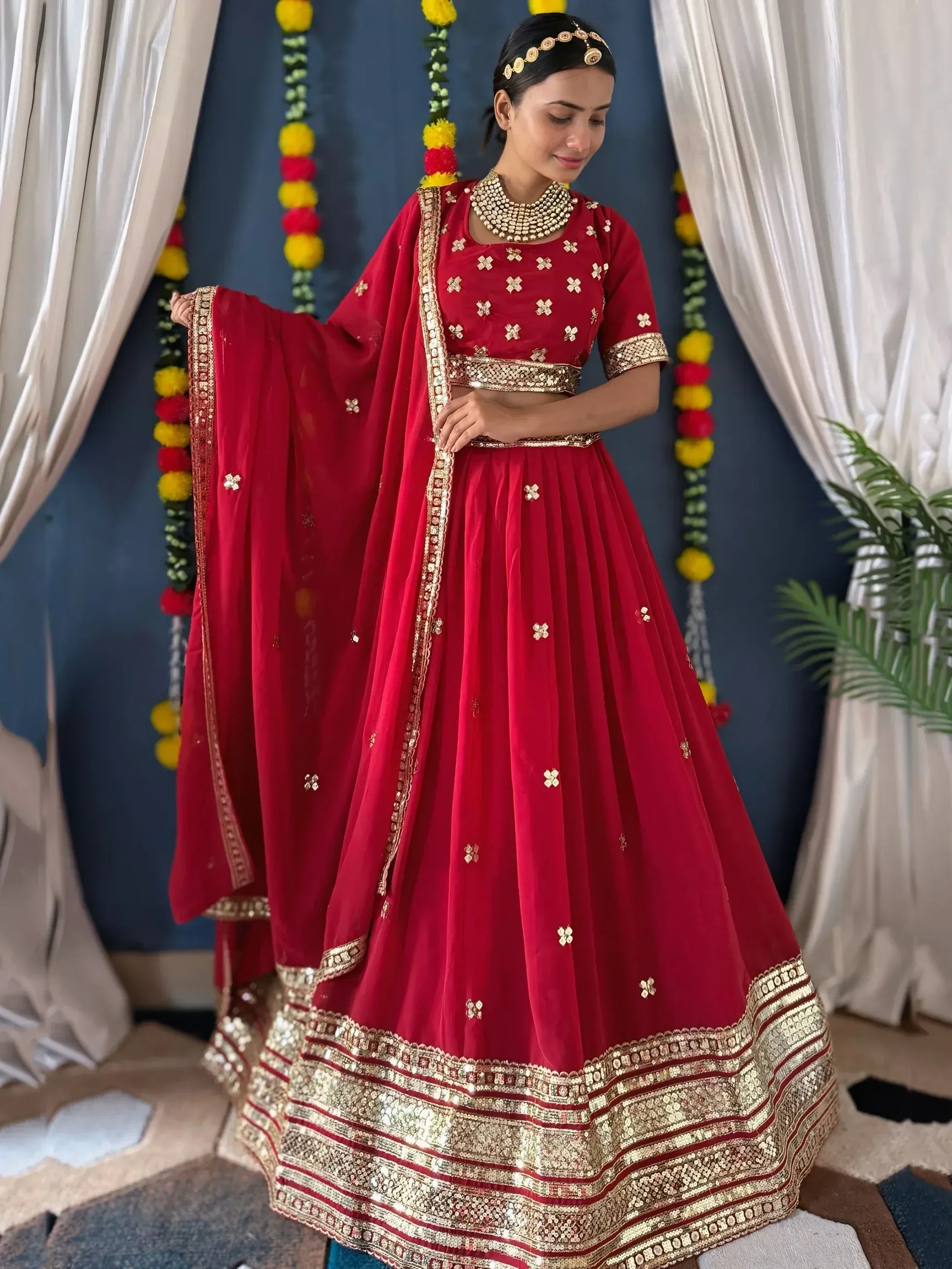 Red designer lehenga choli with gold embroidery and sequin border, perfect for Indian ethnic wear occasions