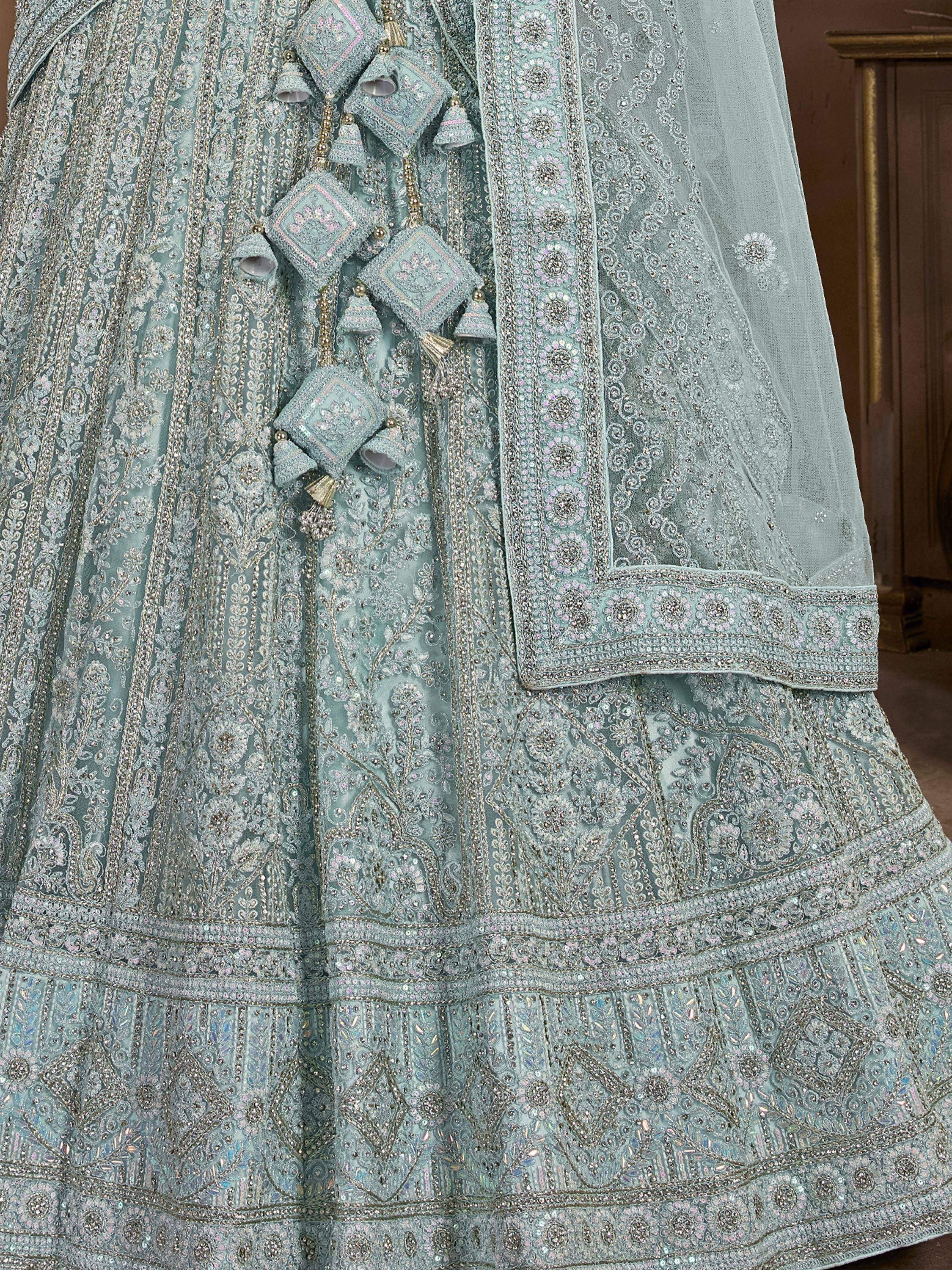 Mint green designer lehenga choli with heavy embroidery, sequins, and tassels for Indian weddings