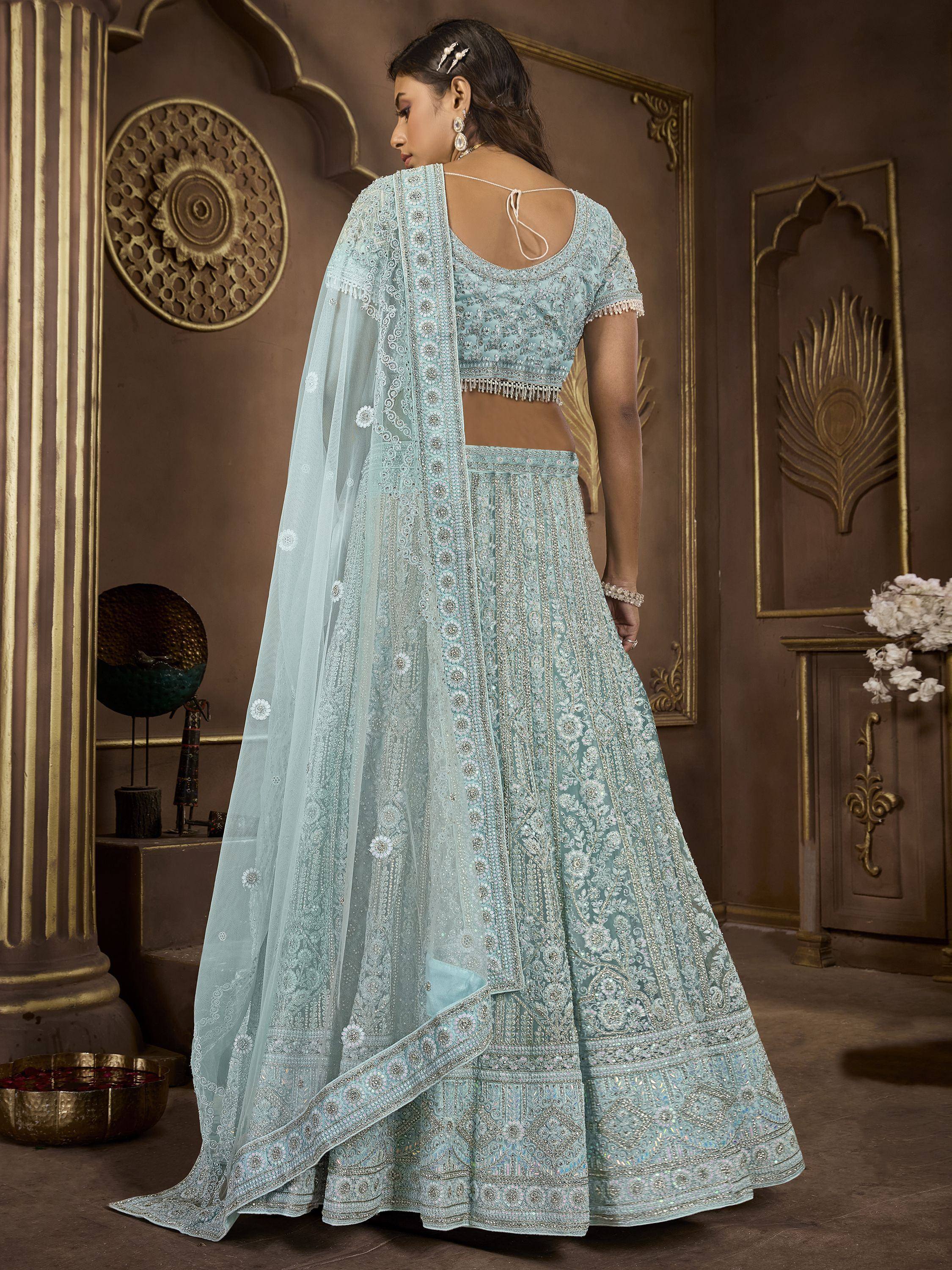 Light blue embroidered lehenga choli with sheer dupatta, perfect for Indian weddings and festive occasions.