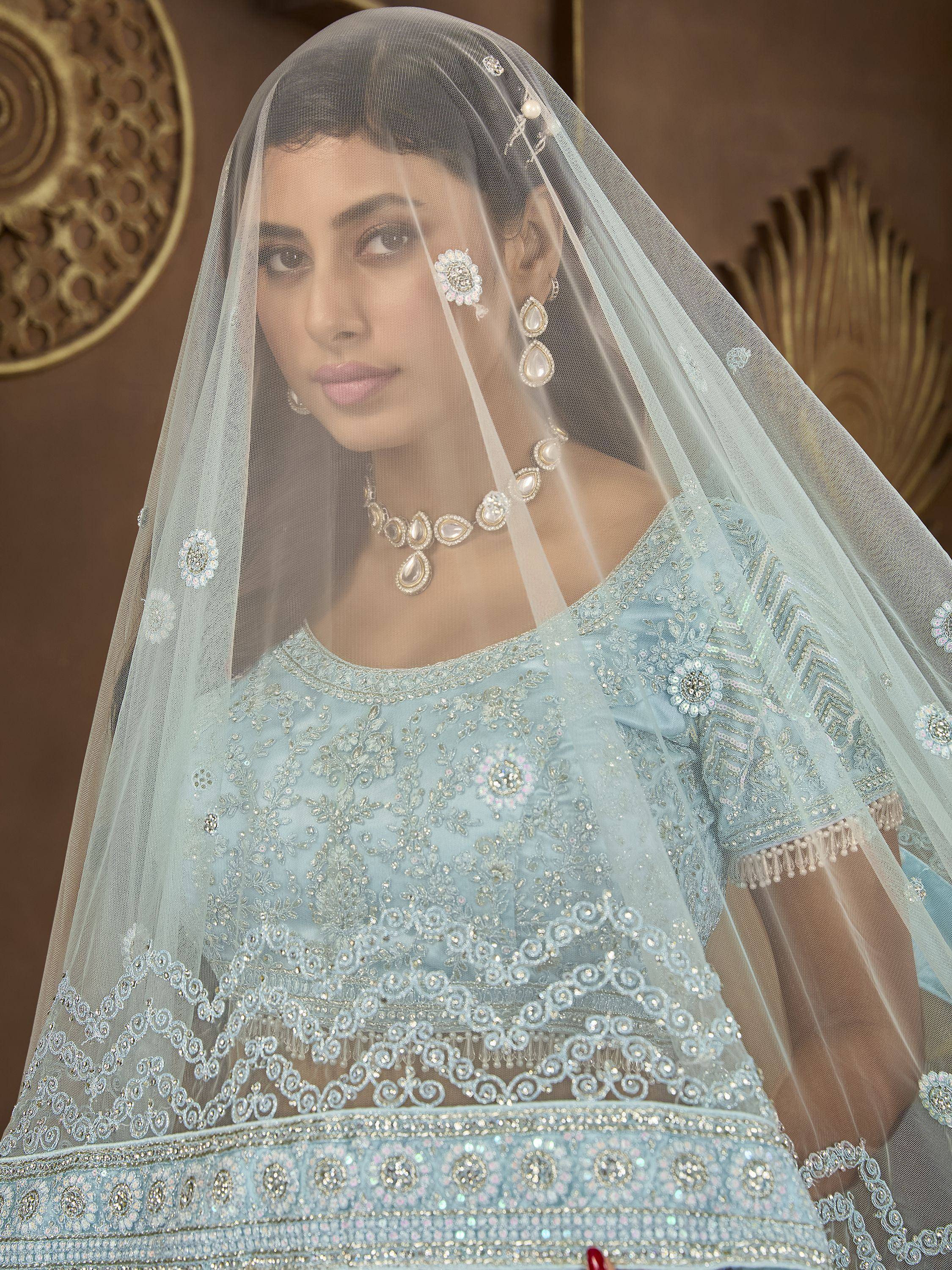 Light blue embroidered lehenga choli with sheer dupatta, perfect for Indian weddings and festive occasions.