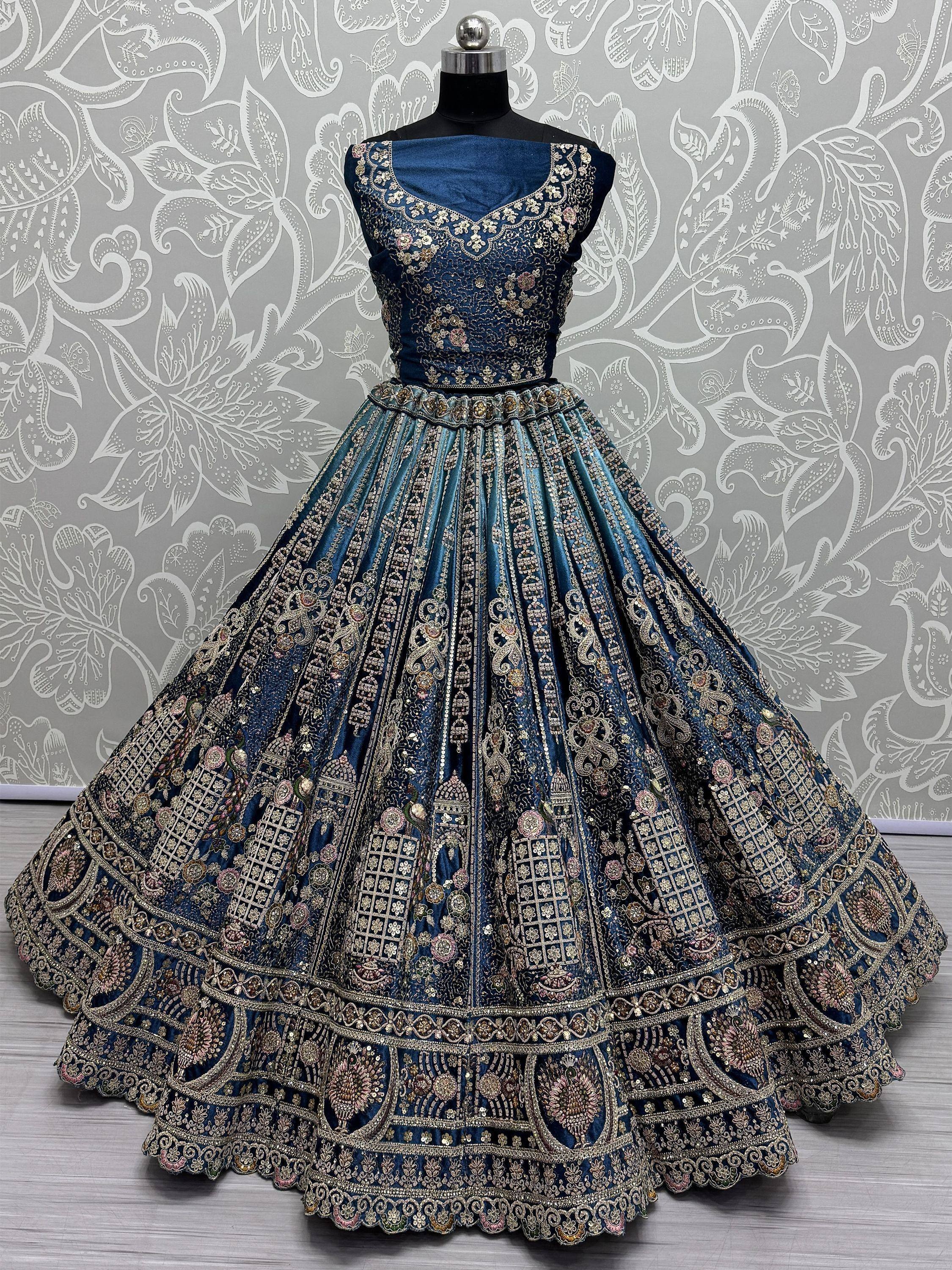 Blue embroidered lehenga choli with gold floral detailing, perfect for Indian weddings and festive occasions.