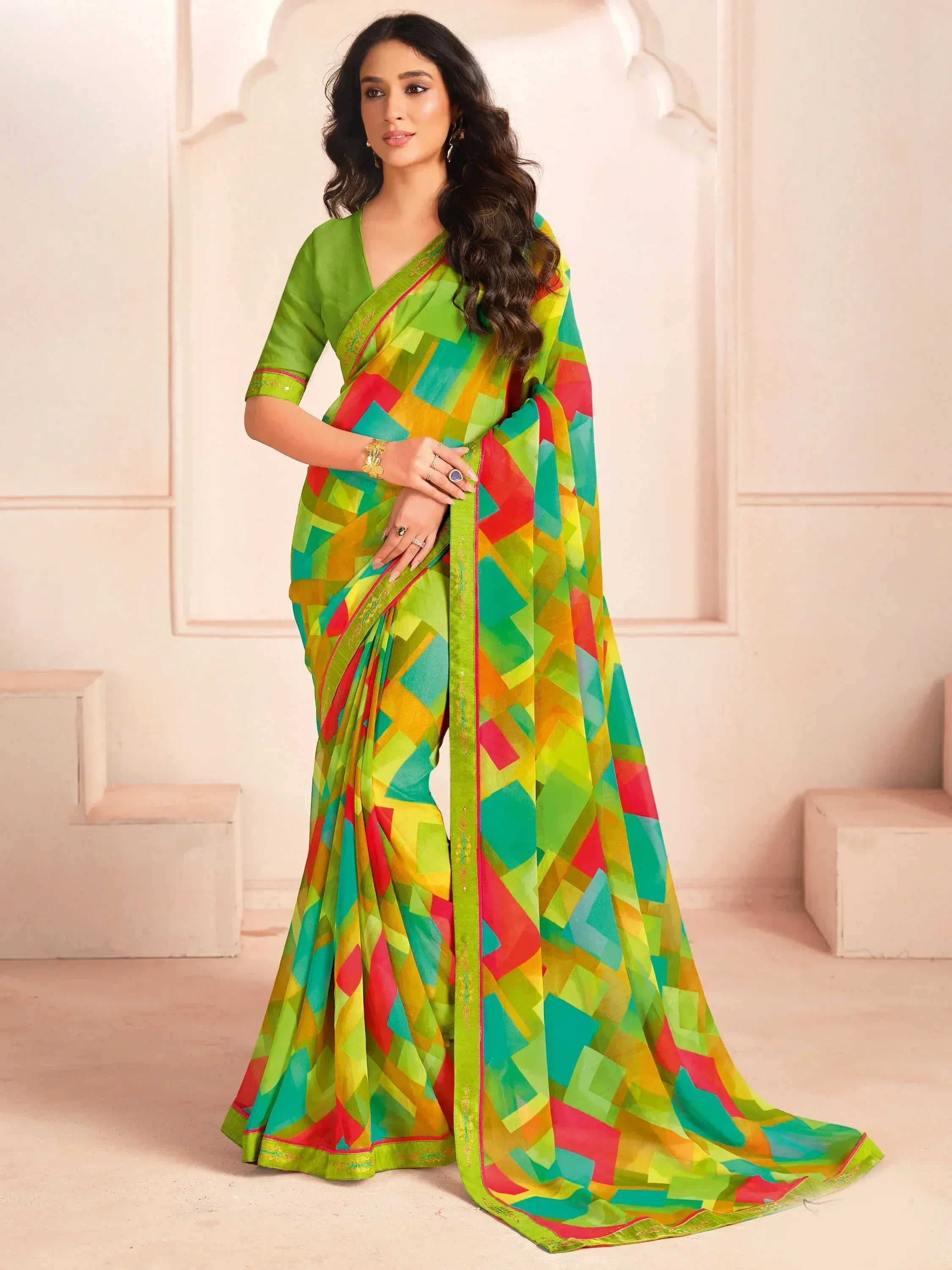 Vibrant geometric print saree in green, red, yellow, and teal with matching blouse, ideal for festive occasions.