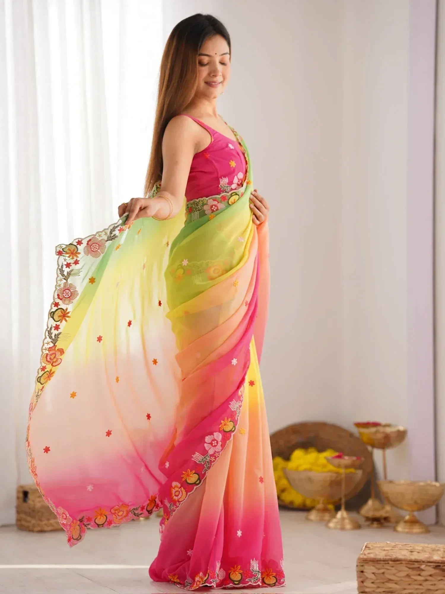 Vibrant floral embroidered saree in gradient pink, yellow, and green hues, perfect for ethnic occasions.