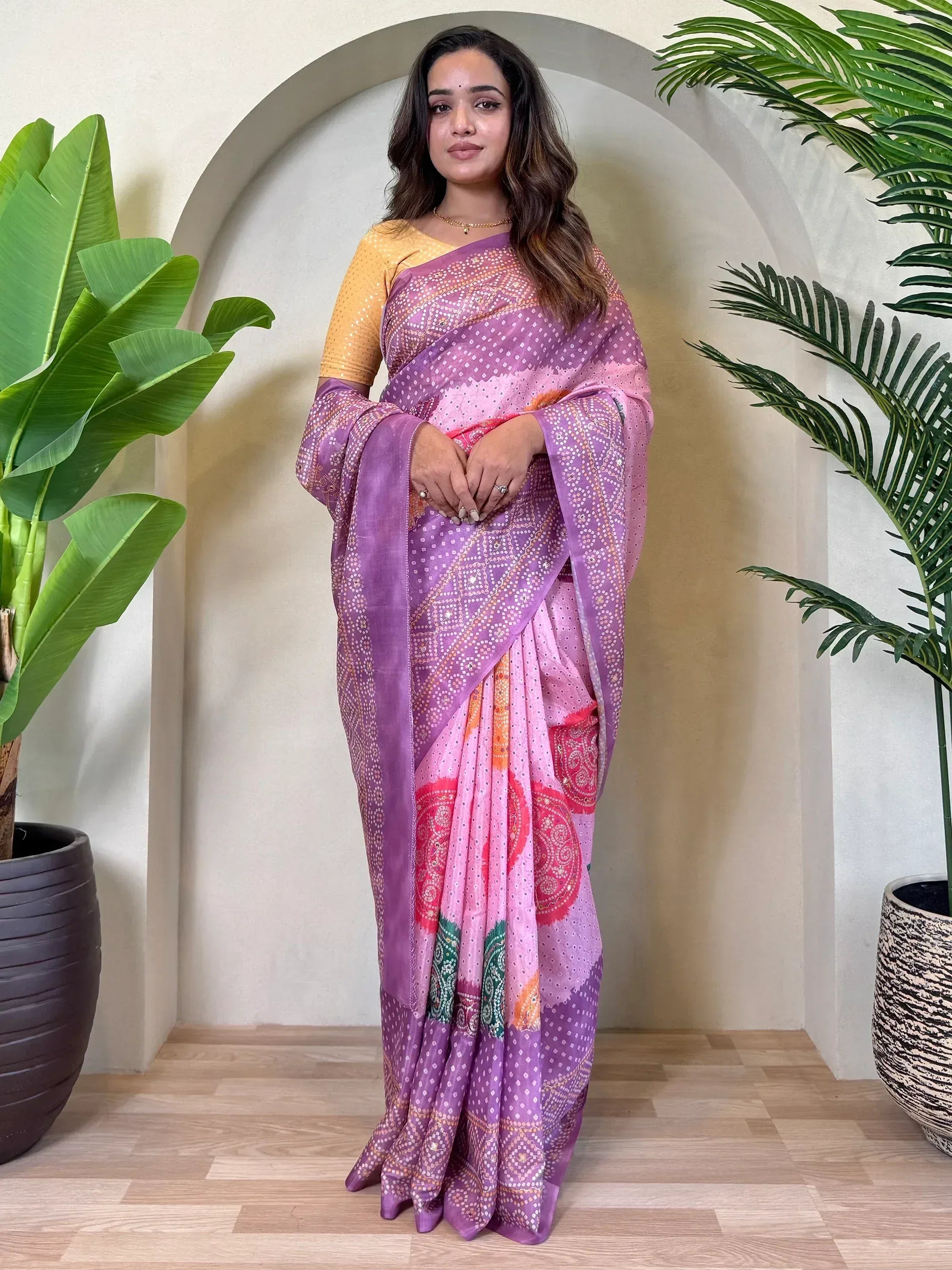 Woman in purple and pink printed saree with yellow blouse, ethnic Indian wear