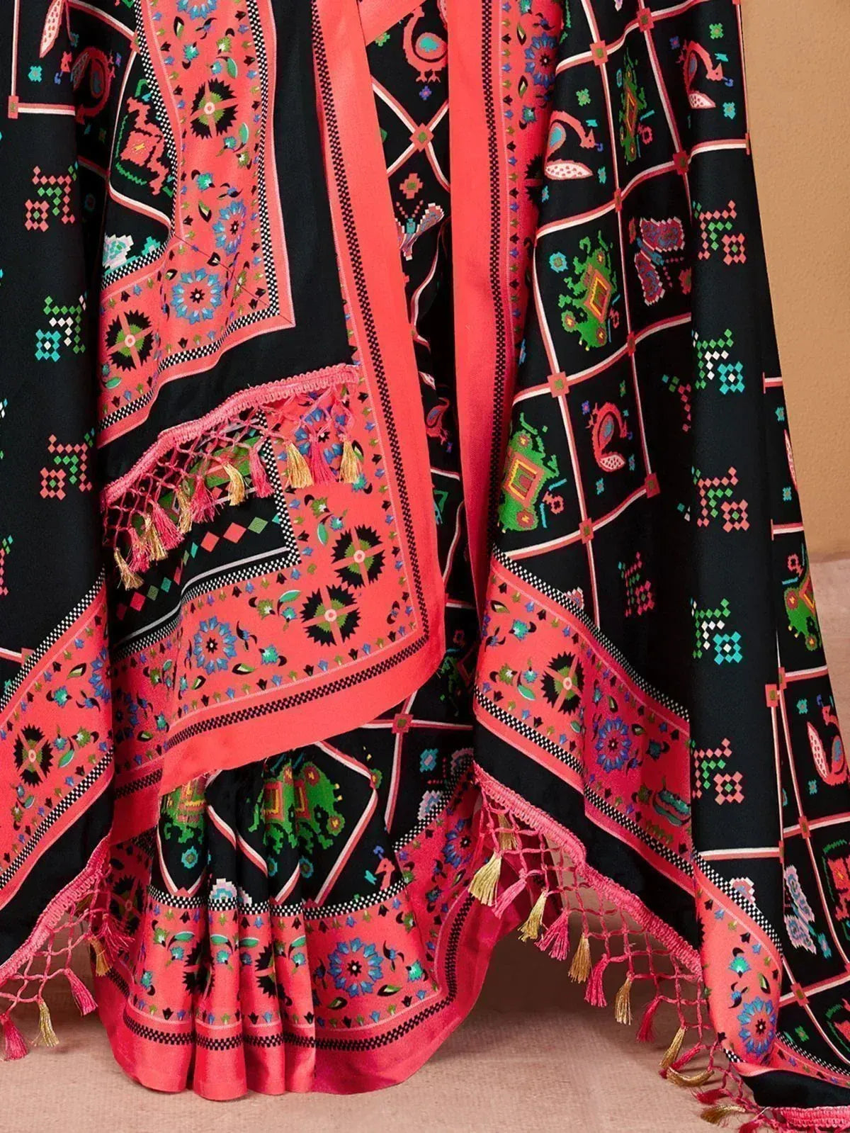 Black and coral ethnic printed lehenga with tassels and floral motifs, perfect for Indian celebrations.